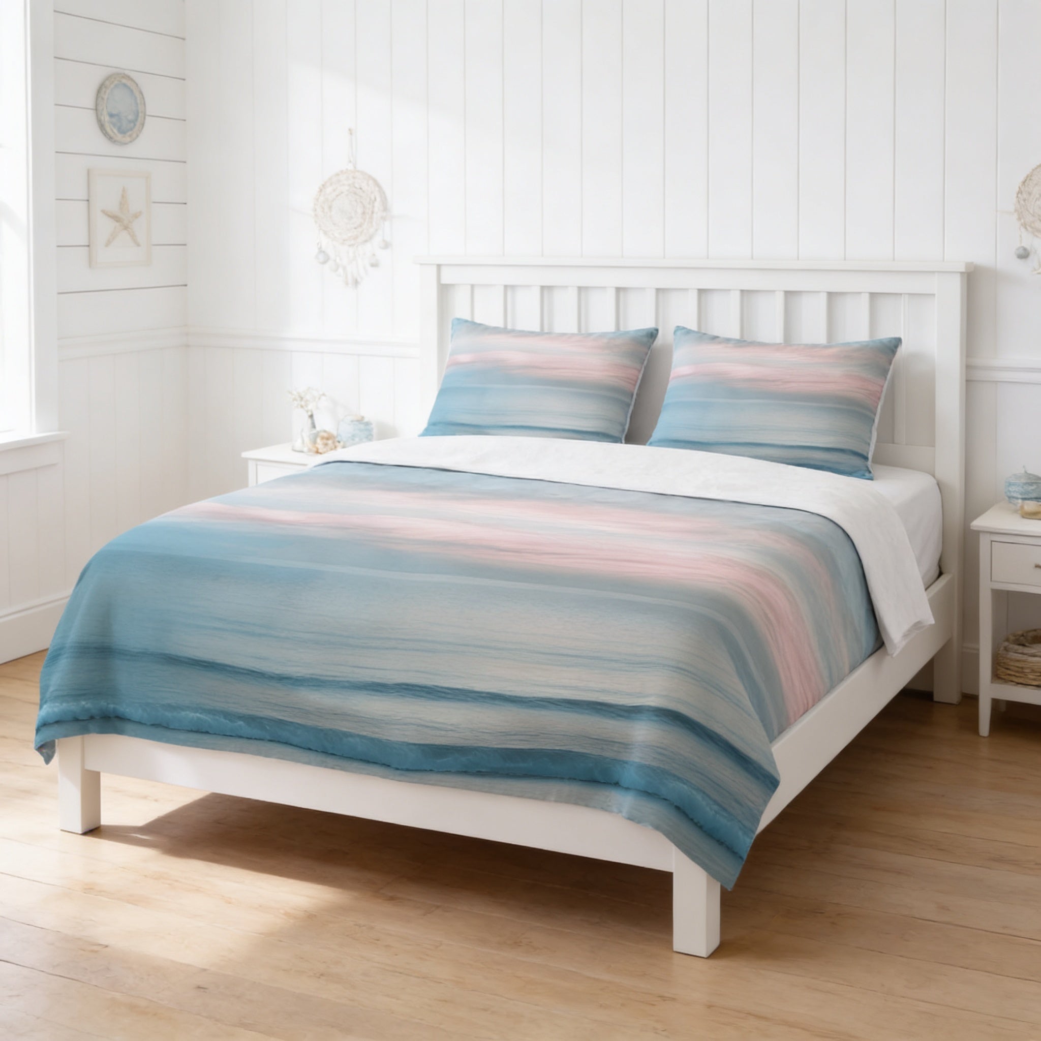 a bedroom with a white wooden bed frame, a colorful striped comforter, and matching pillows. The room has white walls and a wooden floor, creating a clean and bright atmosphere.