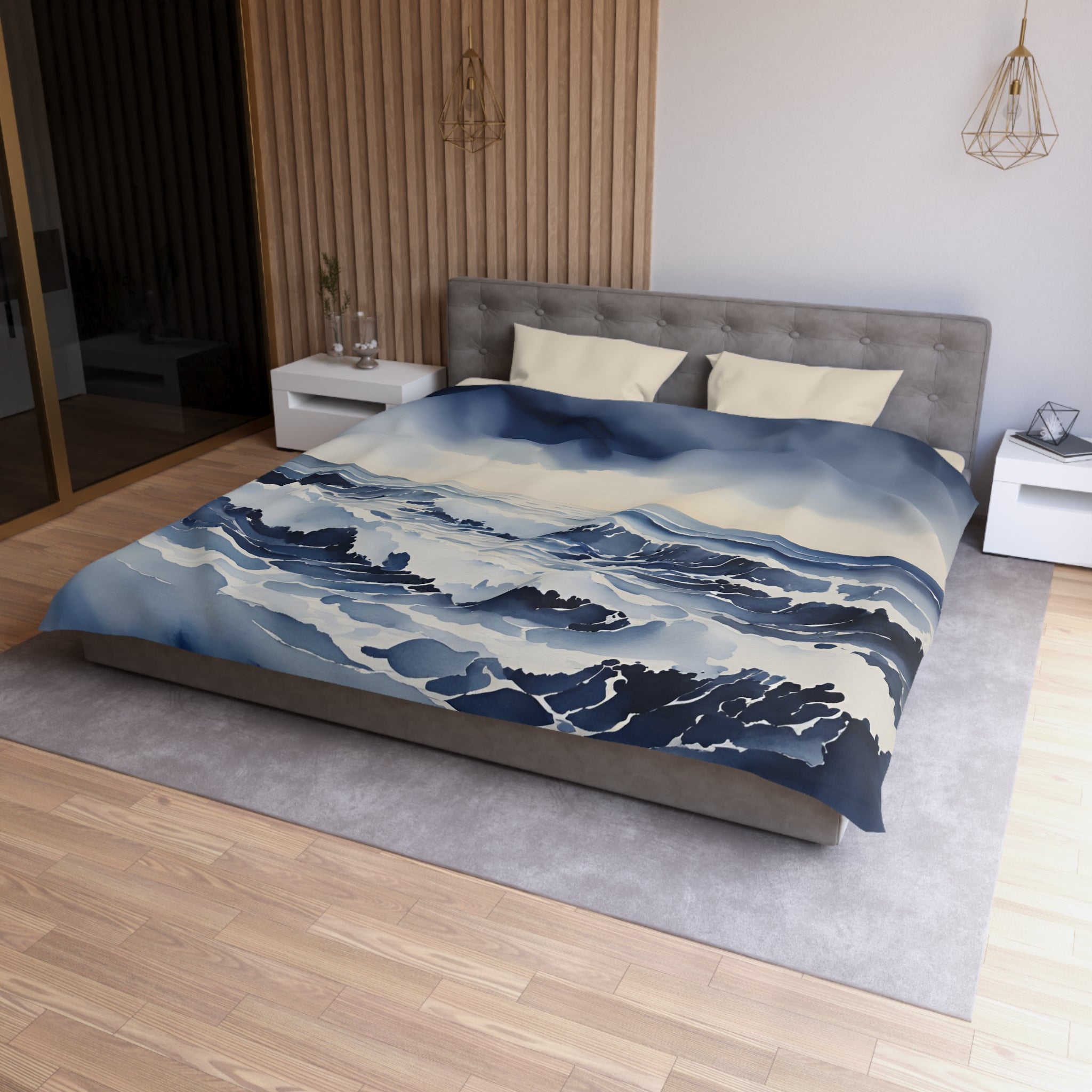 a modern bedroom with a large bed covered in a blue and white ocean-themed duvet cover. The bed is positioned against a wall with a wooden panel, and there are two nightstands on either side of the bed. The room has a minimalist and contemporary design, with a gray headboard and a gray carpet on the floor.