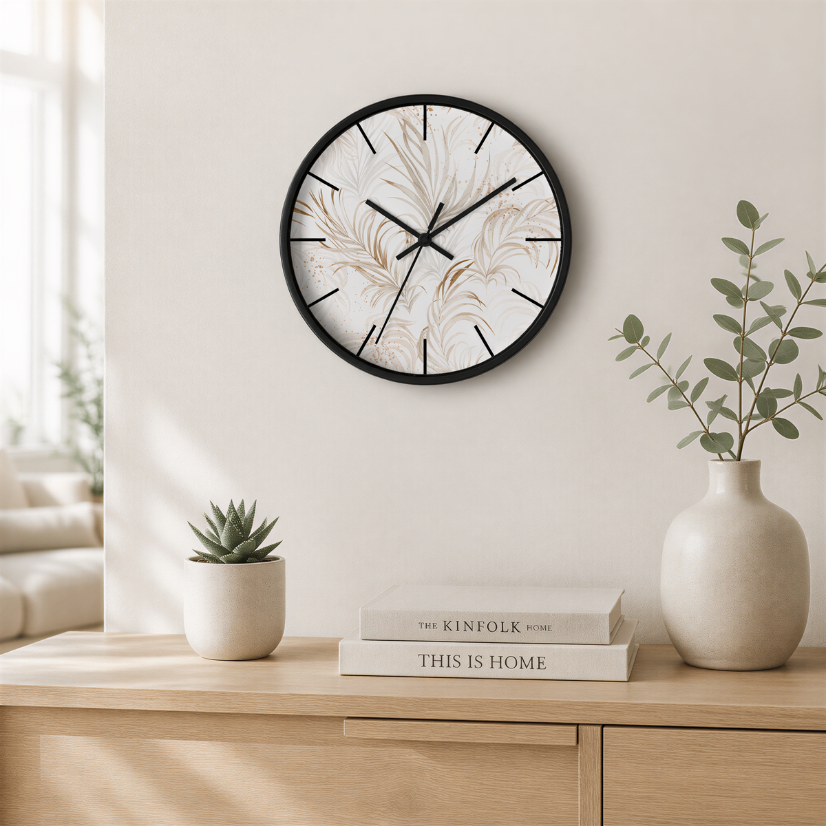 a minimalist living room with a round wall clock displaying a floral pattern, a small potted succulent plant, and a stack of books on a wooden shelf.
