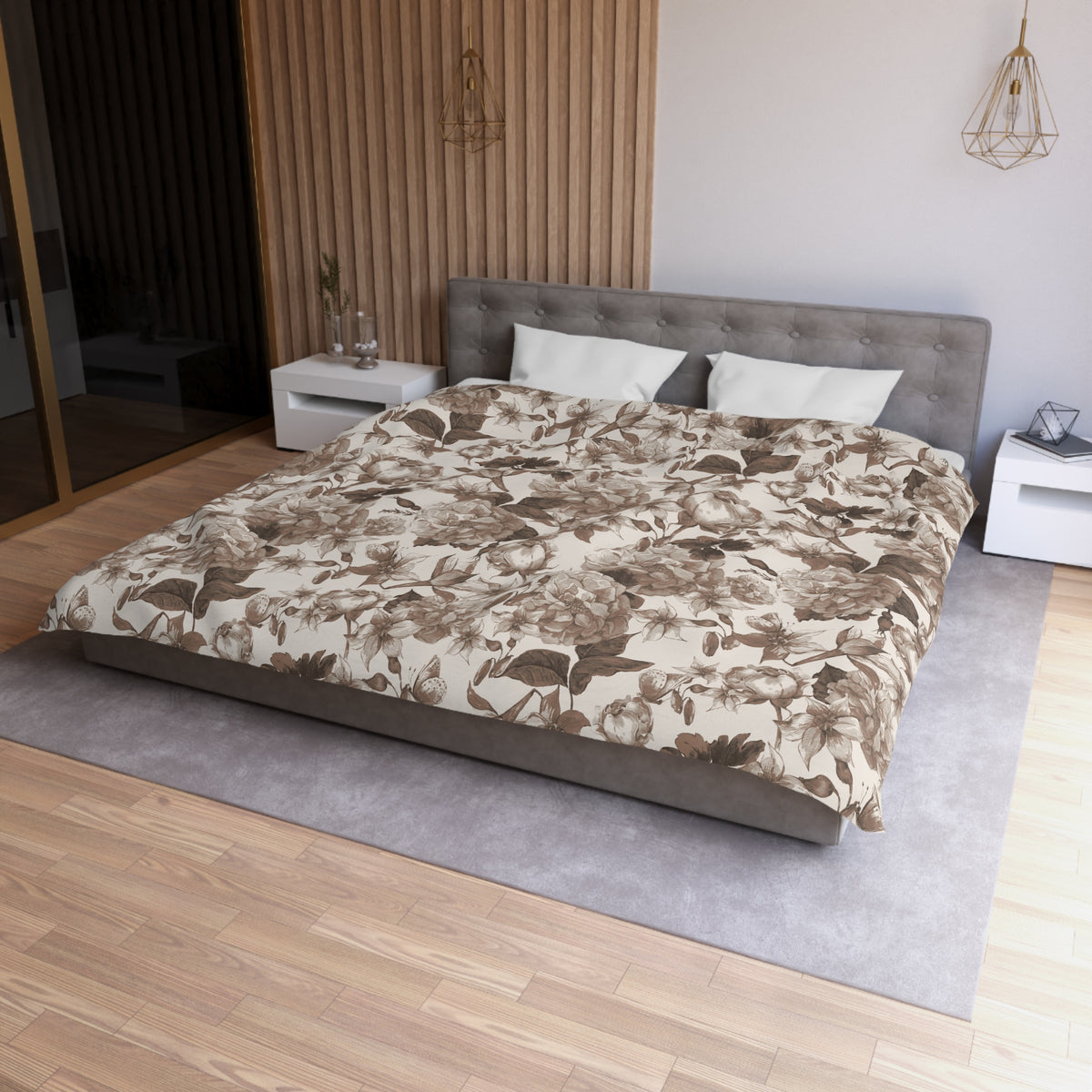 a modern bedroom with a large bed, a gray headboard, and a floral patterned comforter. The room has a wooden floor and white nightstands on either side of the bed.