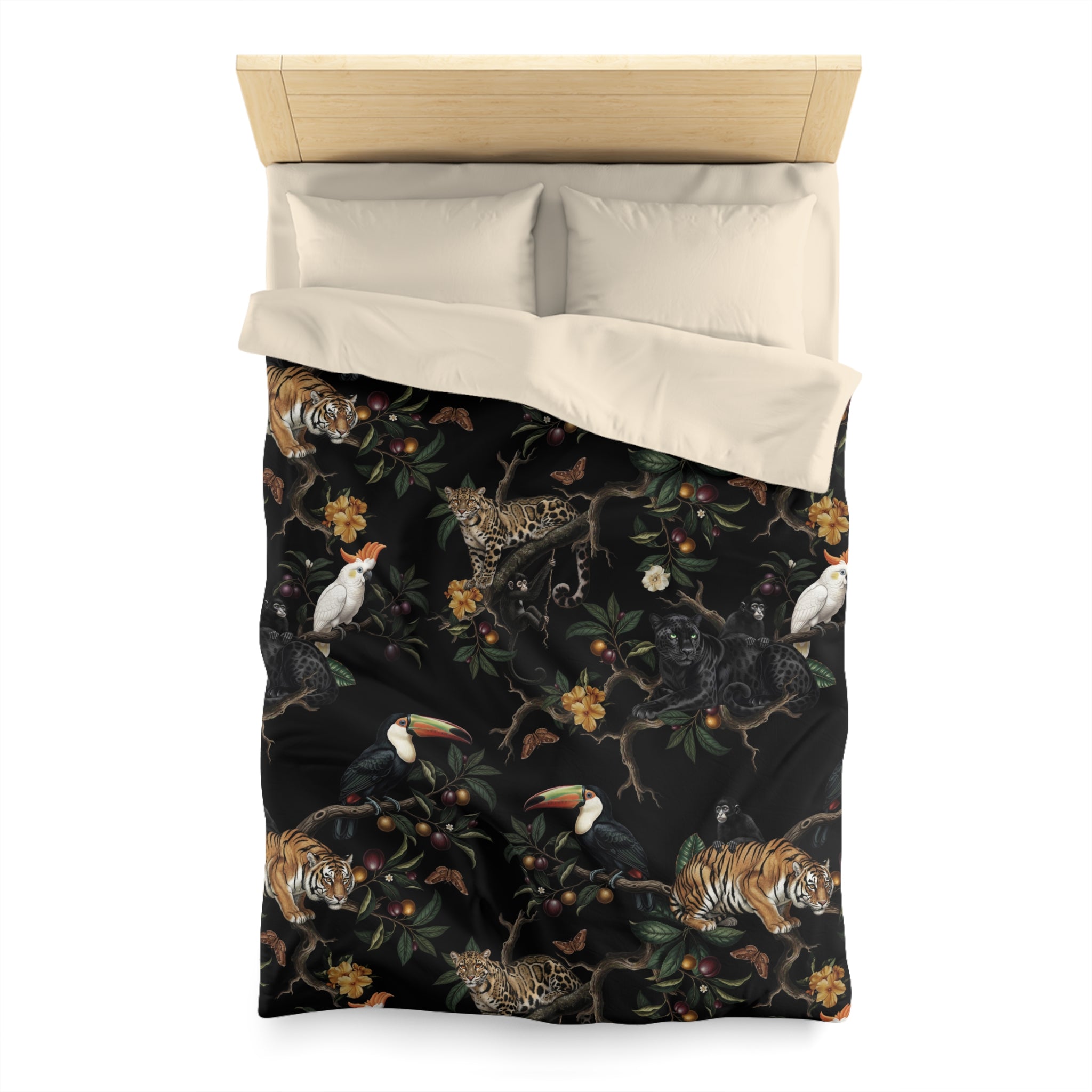 a bed with a black and white patterned comforter and pillows. The pattern includes various animals such as a tiger, bird, and other wildlife elements.