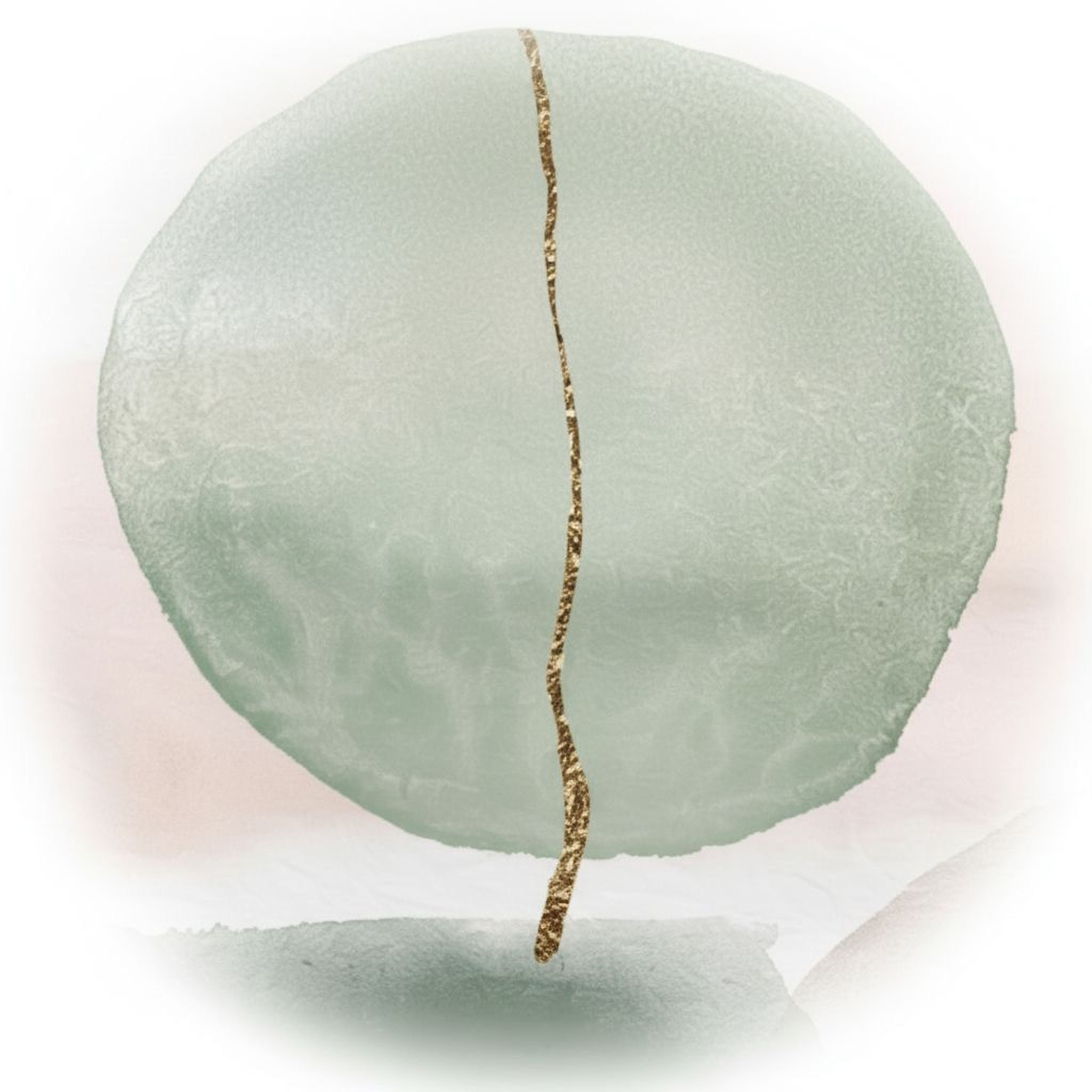 a large, round, green object with a gold line running through it, creating a striking contrast between the two colors.