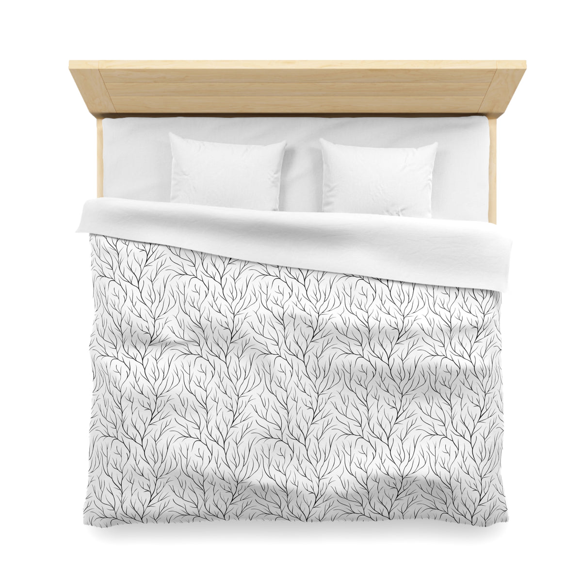 a neatly made bed with a white comforter and a patterned blanket.