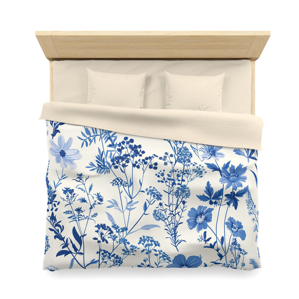 a neatly made bed with a blue and white floral patterned comforter and pillows.