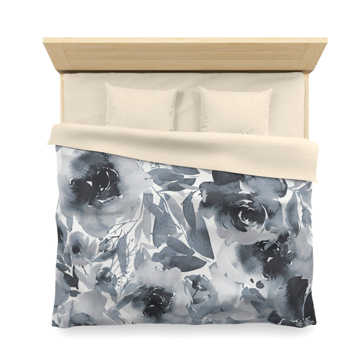 a neatly made bed with a floral print duvet cover and two pillows.