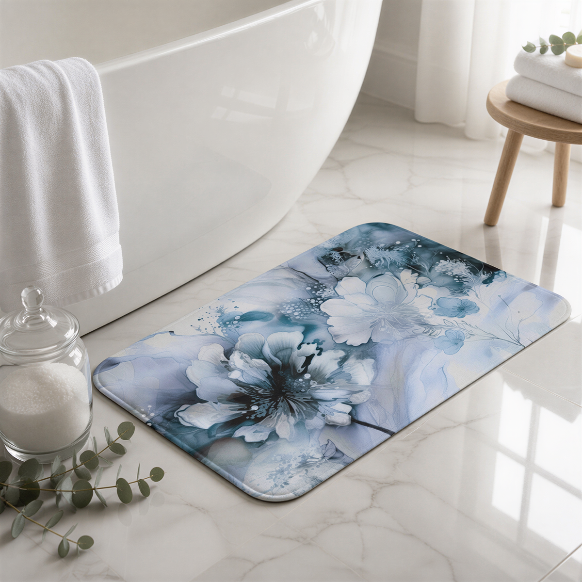 a bathroom with a white bathtub, a blue and white floral bath mat, a glass jar with white sugar, and a wooden stool with a towel on it.