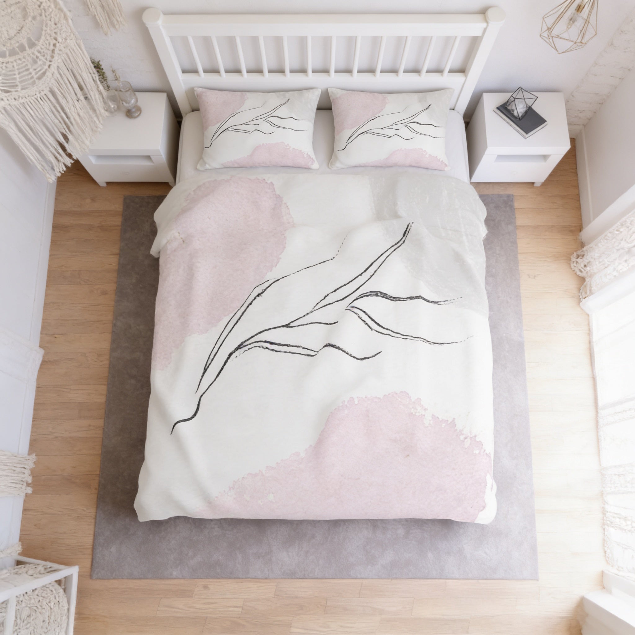 a bedroom with a bed, white nightstands, and a gray rug. The bed has a white comforter with a pink and black abstract design, and the room has a white color scheme with a gray rug.