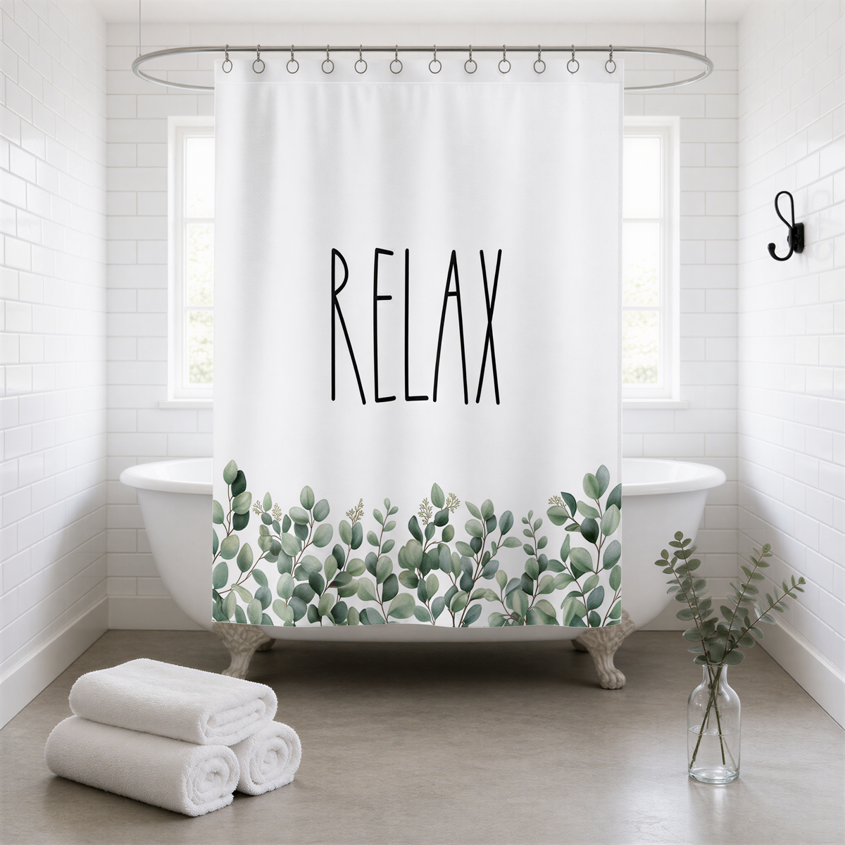 A white bathroom with a bathtub, a shower curtain with the word "RELAX" printed on it, and a vase of greenery on the floor.