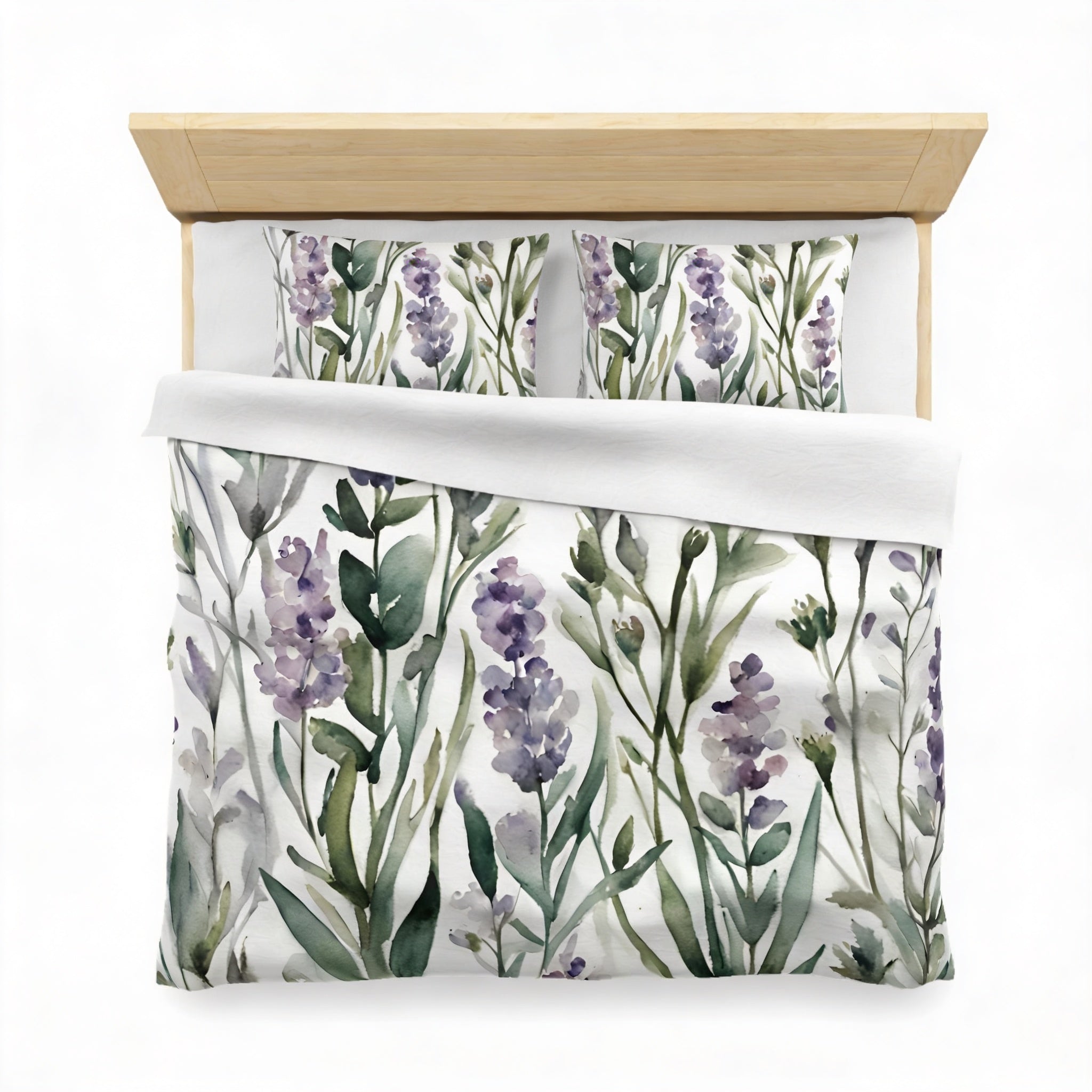 a bed with a white comforter and pillows featuring a floral print in shades of green and purple.