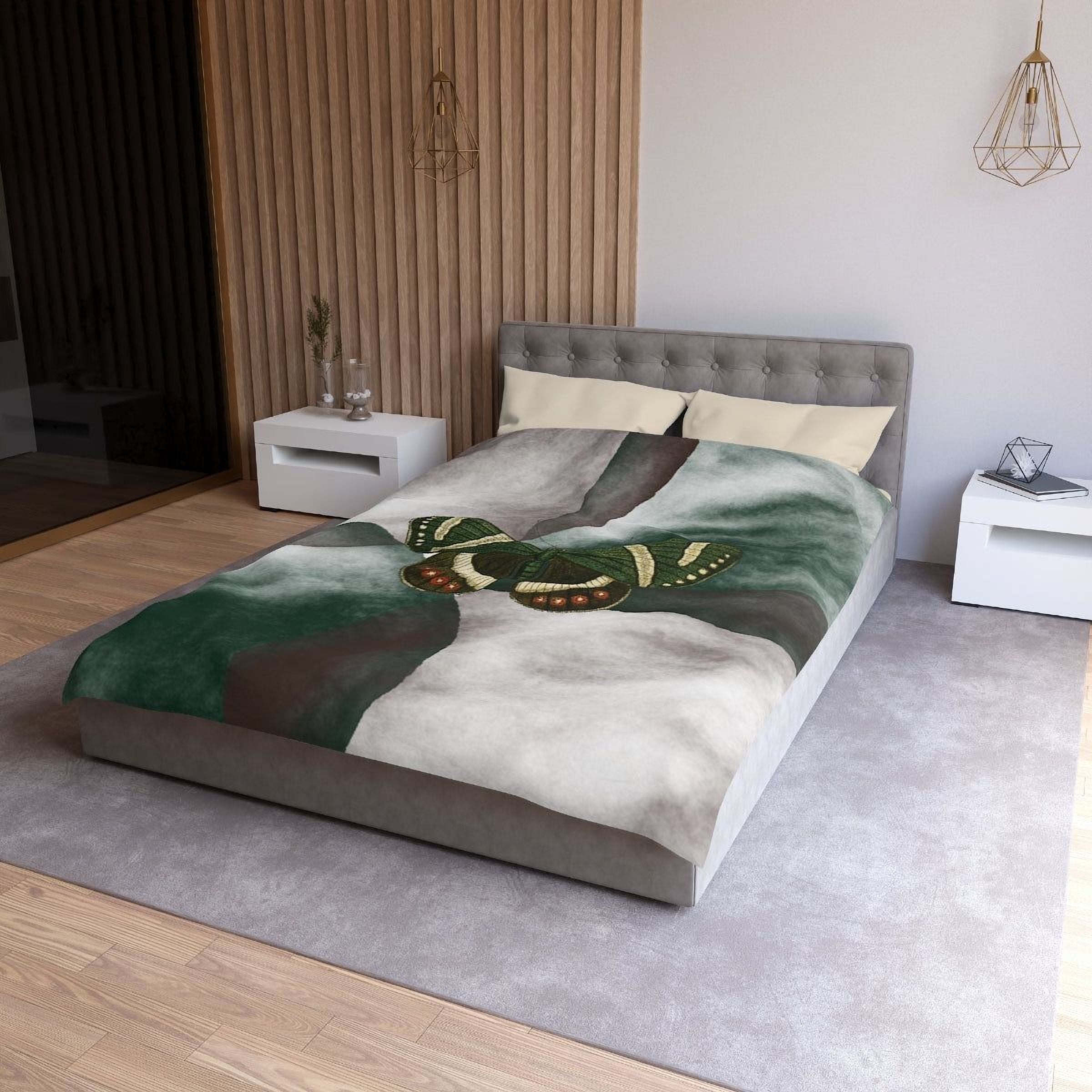 a modern bedroom with a gray tufted headboard, a gray bedspread with a butterfly design, and a white nightstand on the left side of the bed.
