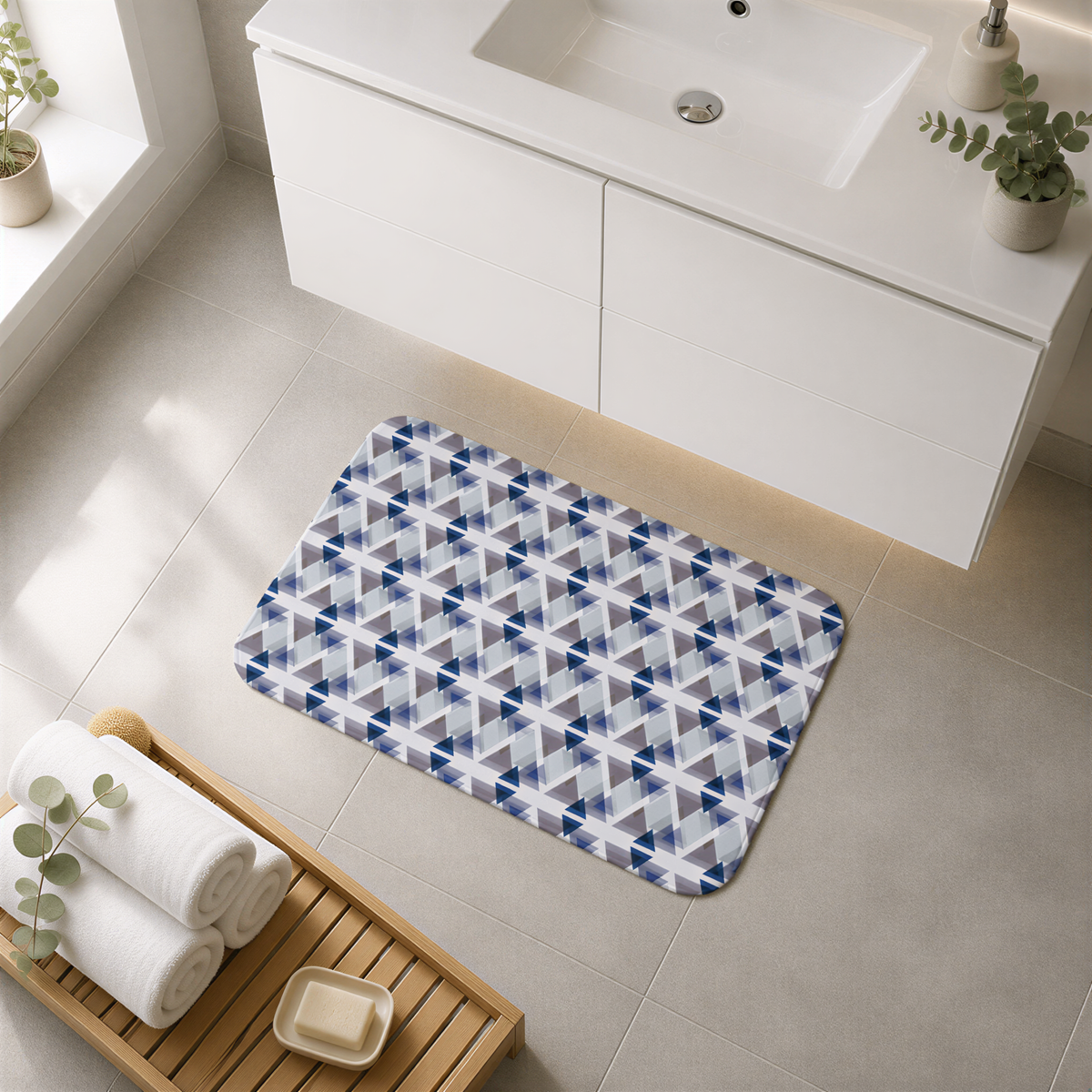 a bathroom with a white sink, a wooden tray with rolled towels, a patterned bath mat, and a small plant on the windowsill.