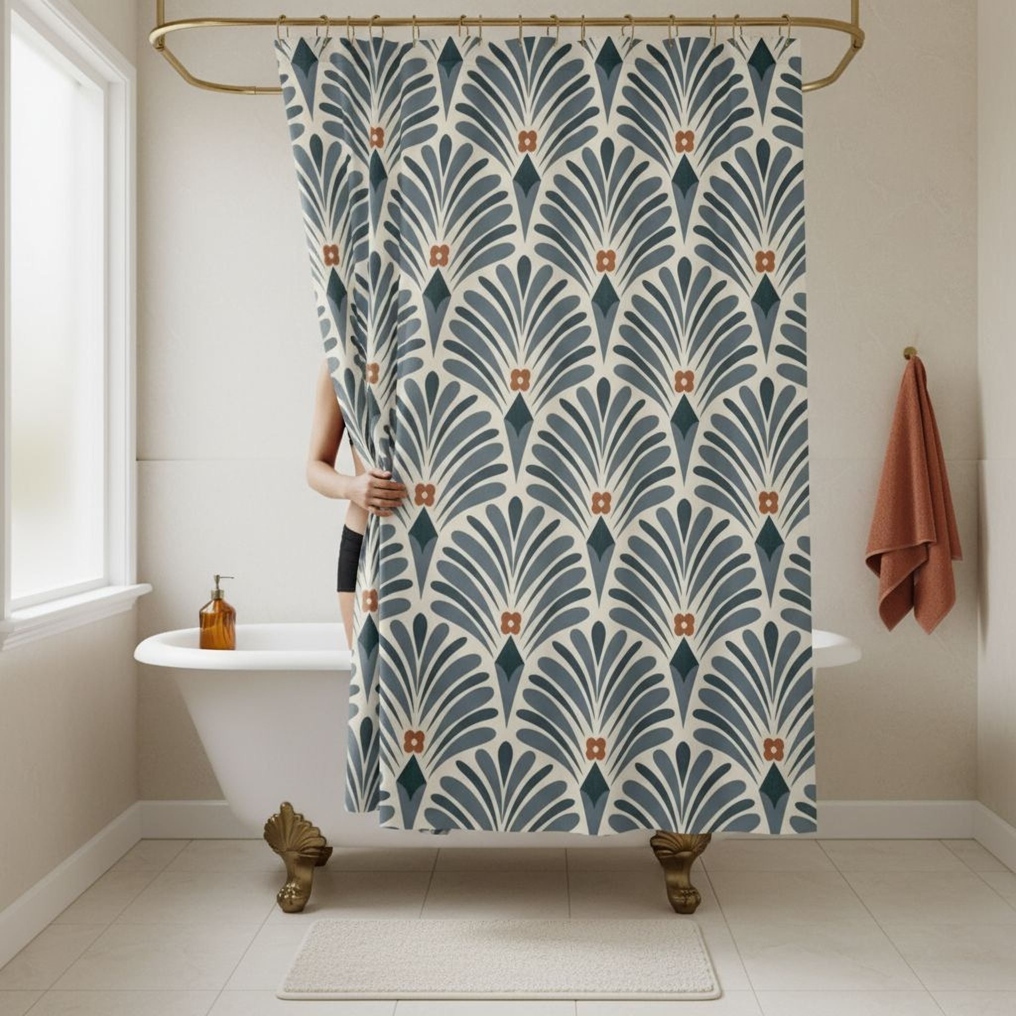 a bathroom with a white clawfoot bathtub, a shower curtain with a blue and white floral pattern, and a towel hanging on a rack.