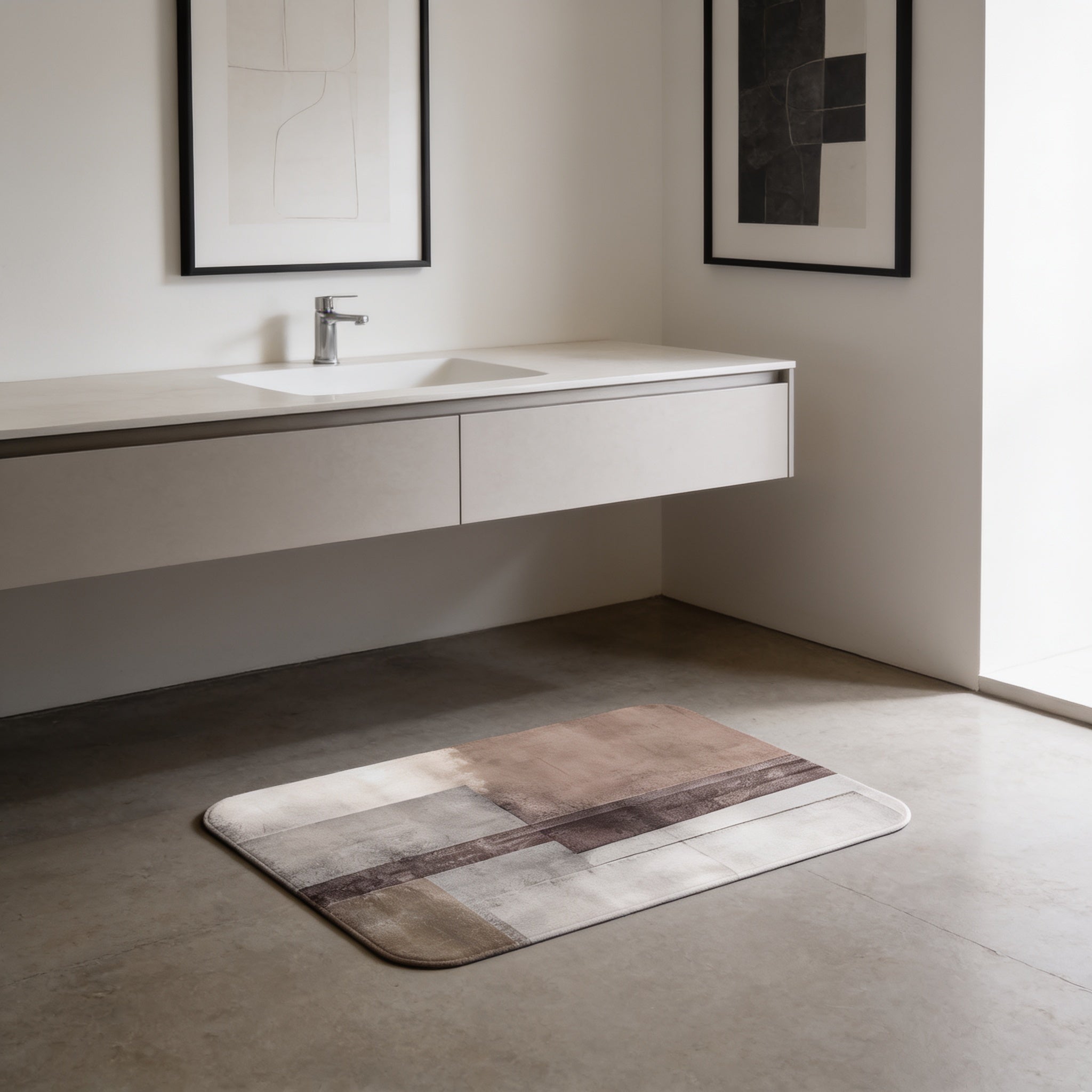 a modern bathroom with a white sink, a framed artwork on the wall, and a rug on the floor.