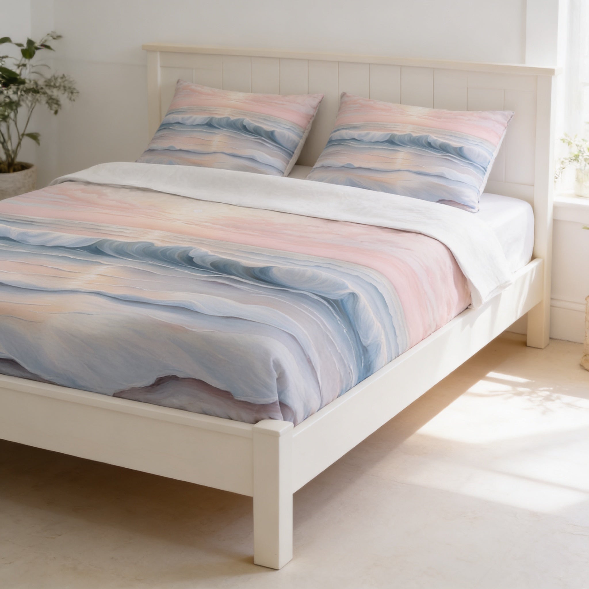 a white wooden bed with a colorful, patterned comforter and pillows. The bed is positioned against a white wall, and there is a potted plant and a vase nearby.