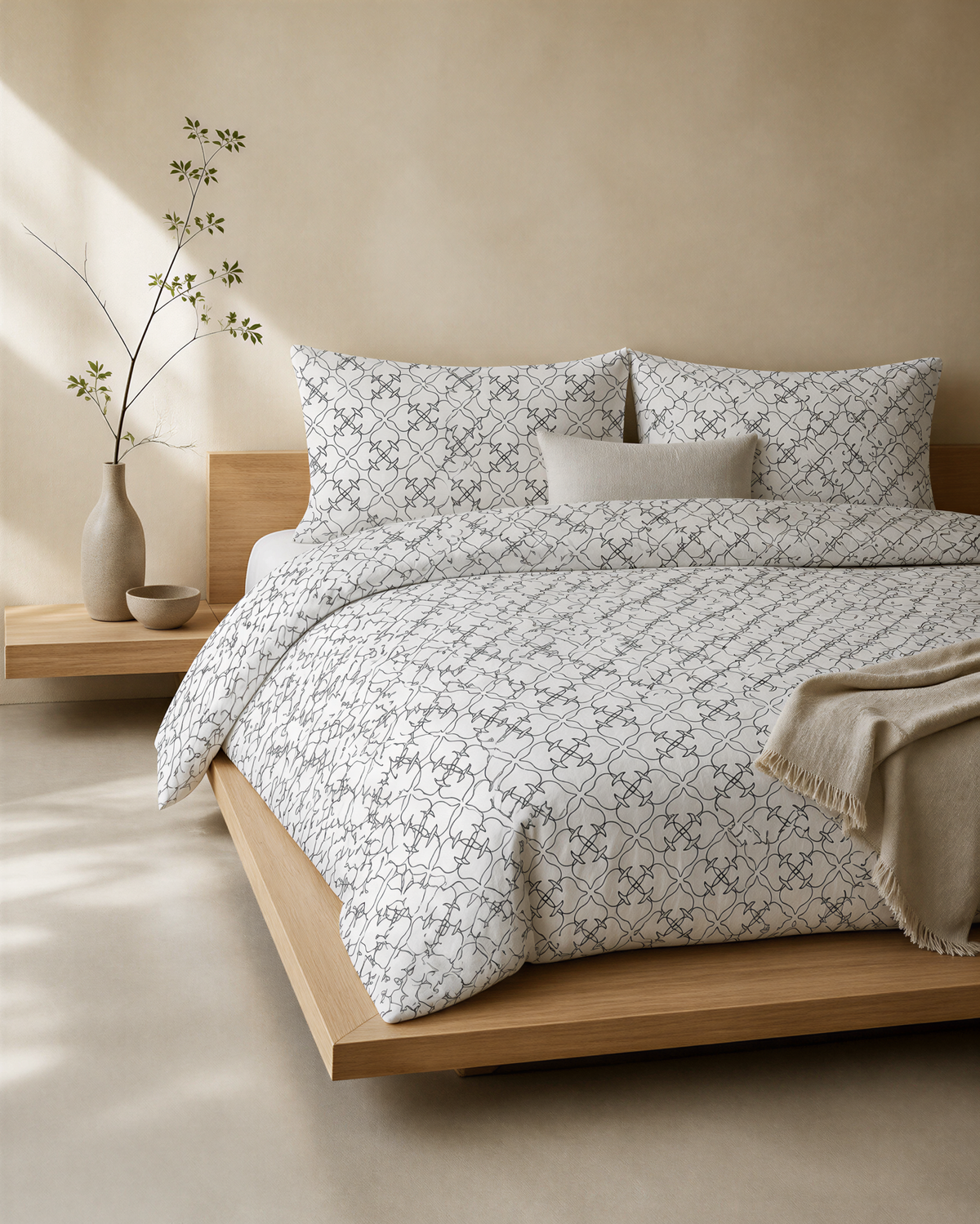 a serene and modern bedroom with a wooden bed frame, a patterned comforter, and a wooden nightstand with a vase of greenery.