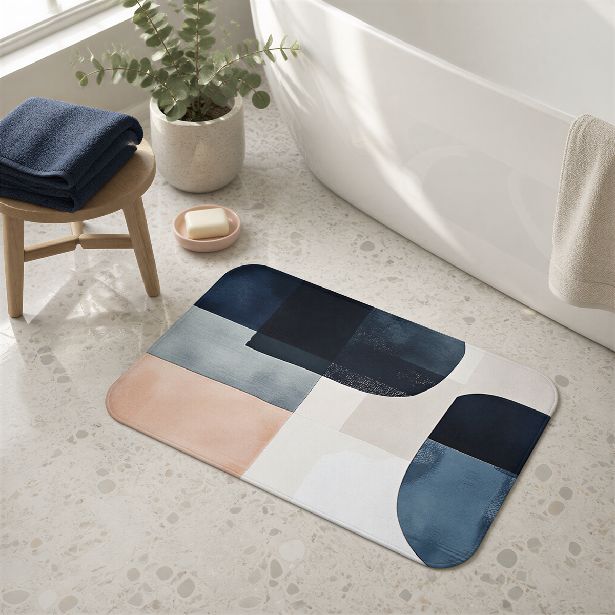 a bathroom with a colorful geometric bath mat, a blue towel, a wooden stool, and a potted plant.