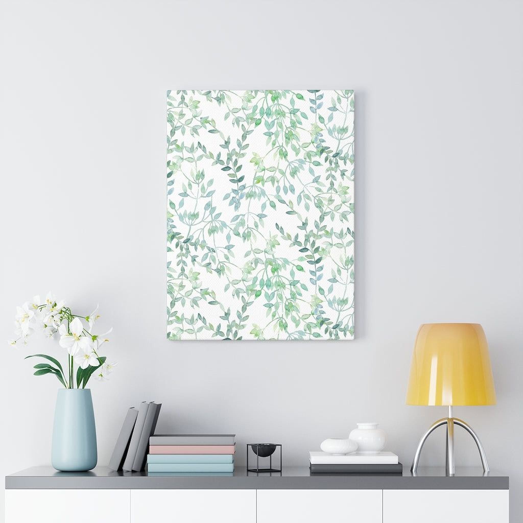 a minimalist living space with a white wall, a shelf holding a blue vase with white flowers, a stack of books, a lamp, and a framed print of a green leaf pattern.