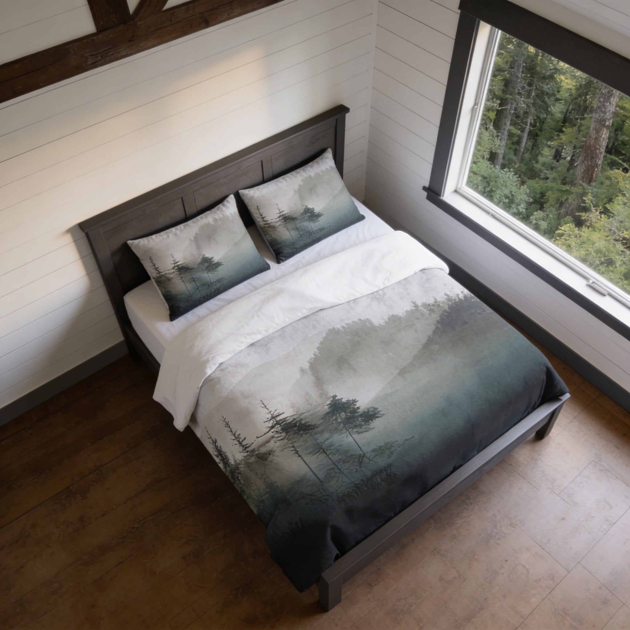 a bedroom with a bed featuring a nature-inspired duvet cover and matching pillows. The bed is positioned against a wall with a window, providing a view of the surrounding environment.