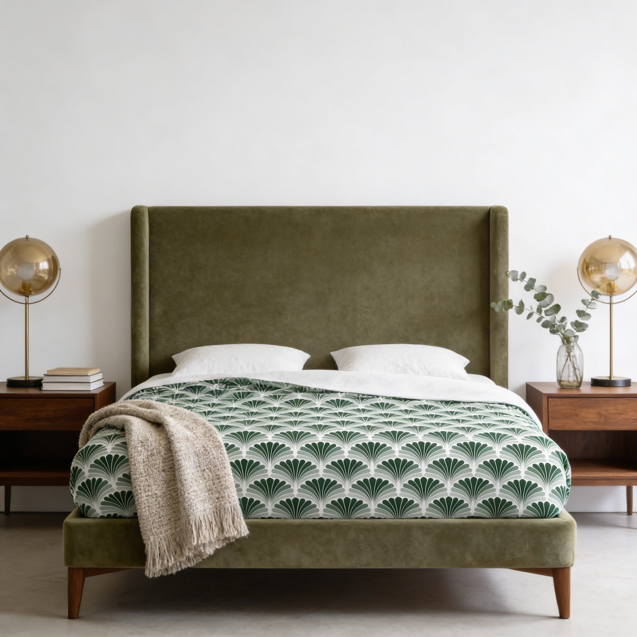 a modern bedroom with a large bed, a green headboard, and two nightstands with lamps. The bed has a green and white patterned bedspread, and there is a beige throw blanket on the bed. The room has a minimalist and clean design, with white walls and a wooden floor.