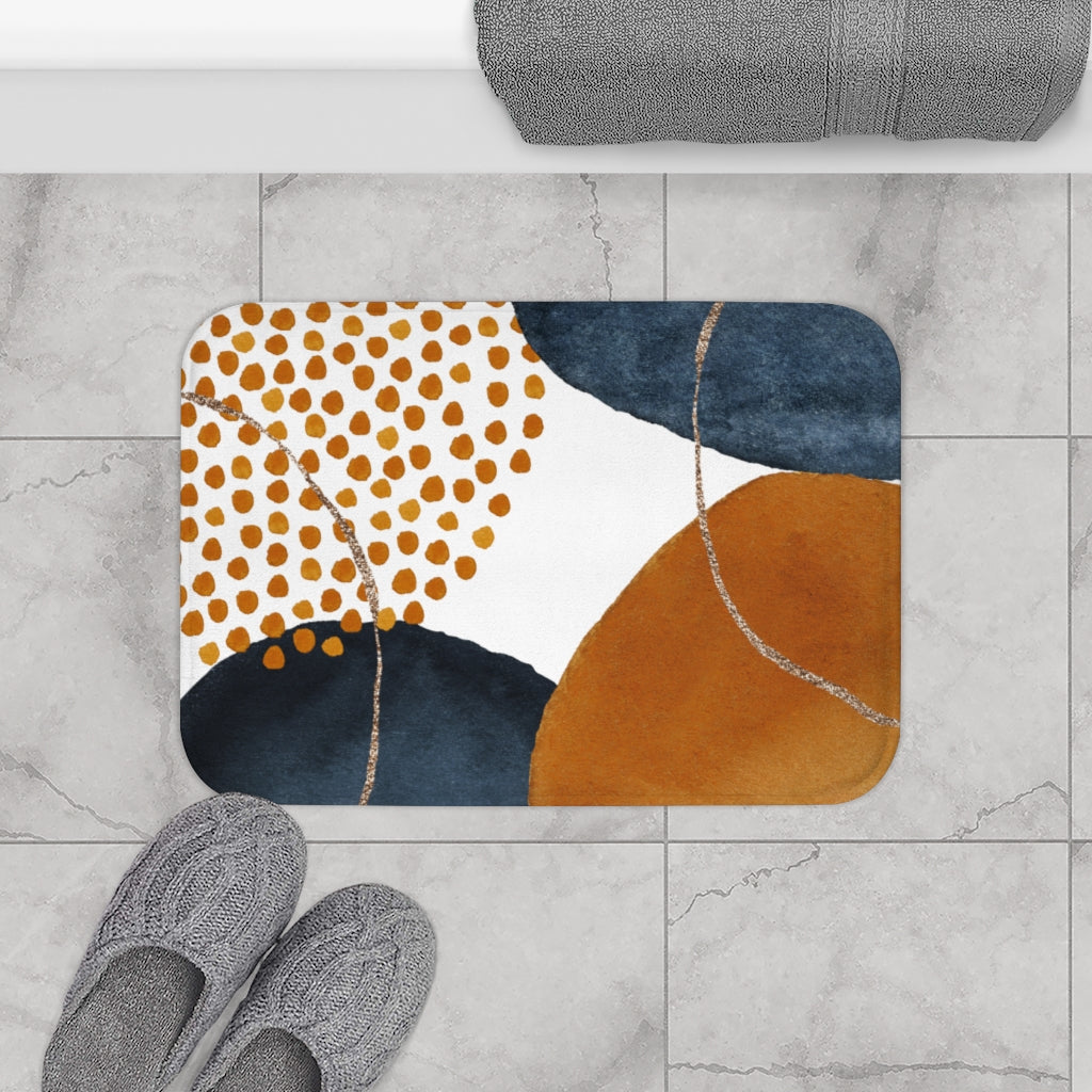 Navy blue and burnt orange boho bath mat in a bright bathroom