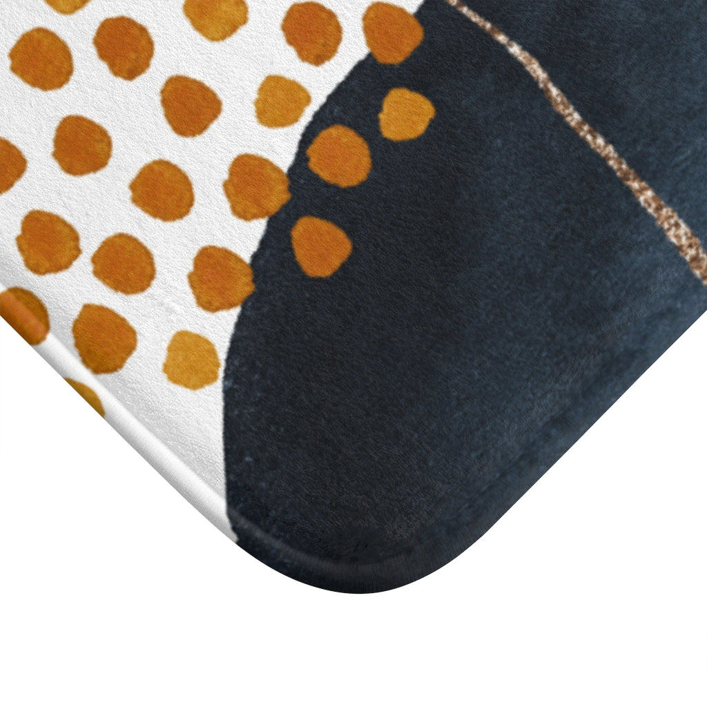 Navy blue and burnt orange boho bath mat, close-up of the texture