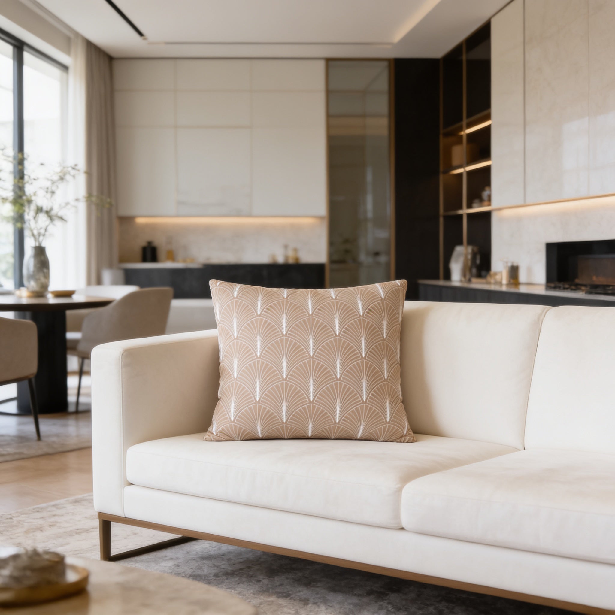 a modern living room with a white sofa, a decorative pillow, and a dining table with chairs. The room has a clean and minimalist design, with white walls and a neutral color palette.