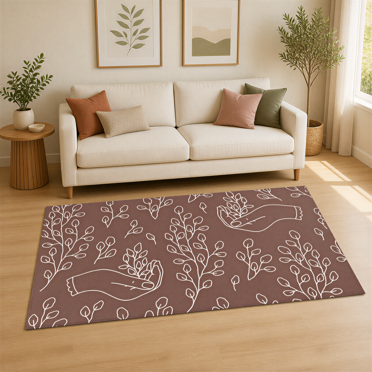 a living room with a white sofa, a rug with a leafy plant design, and two framed pictures on the wall.