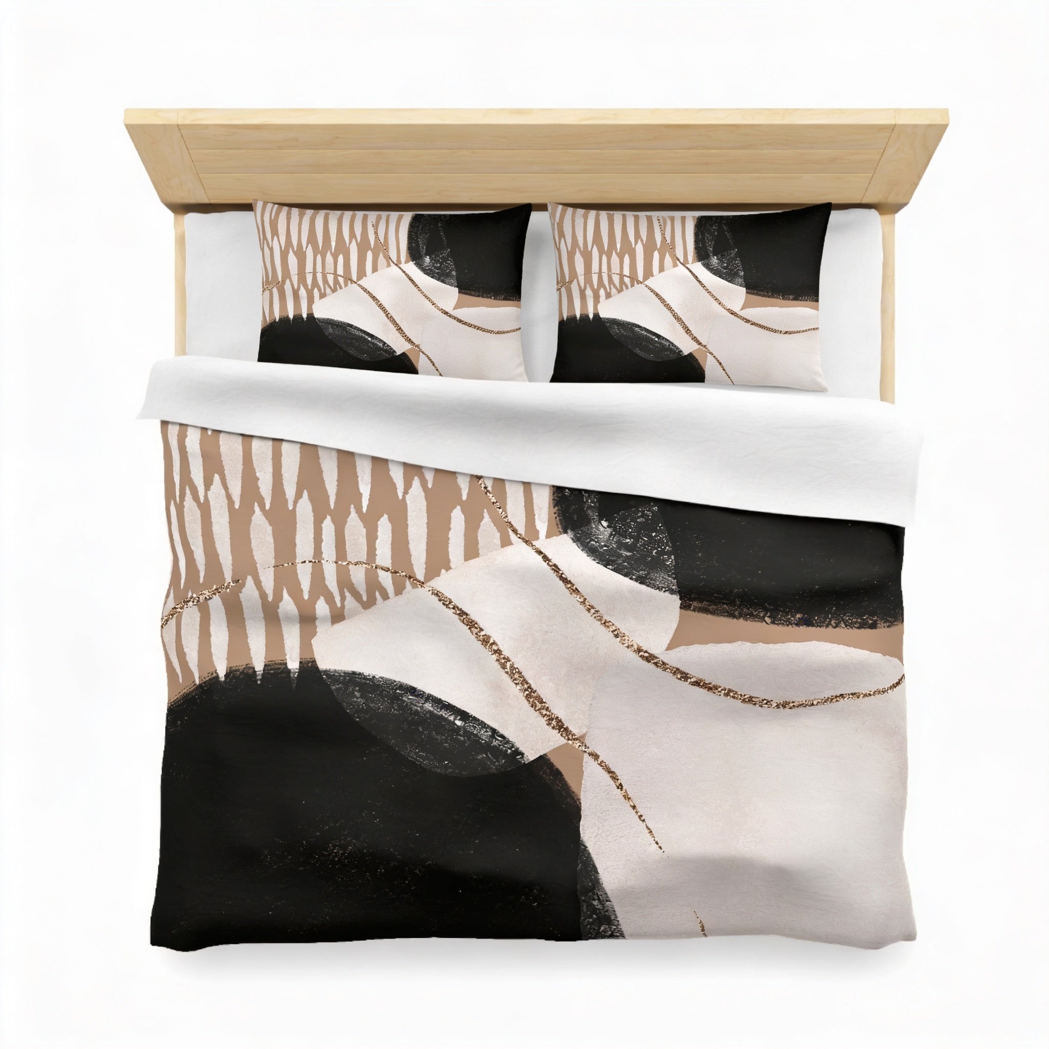 a bed with a black and white abstract patterned comforter and matching pillows.