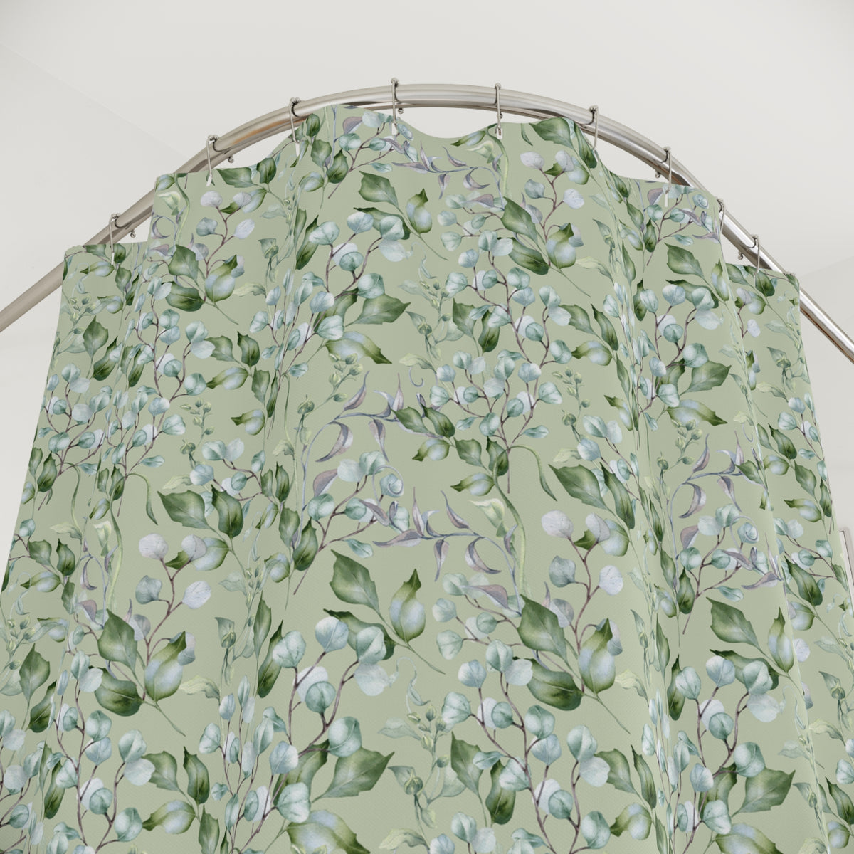 a shower curtain with a floral pattern of green leaves and flowers.