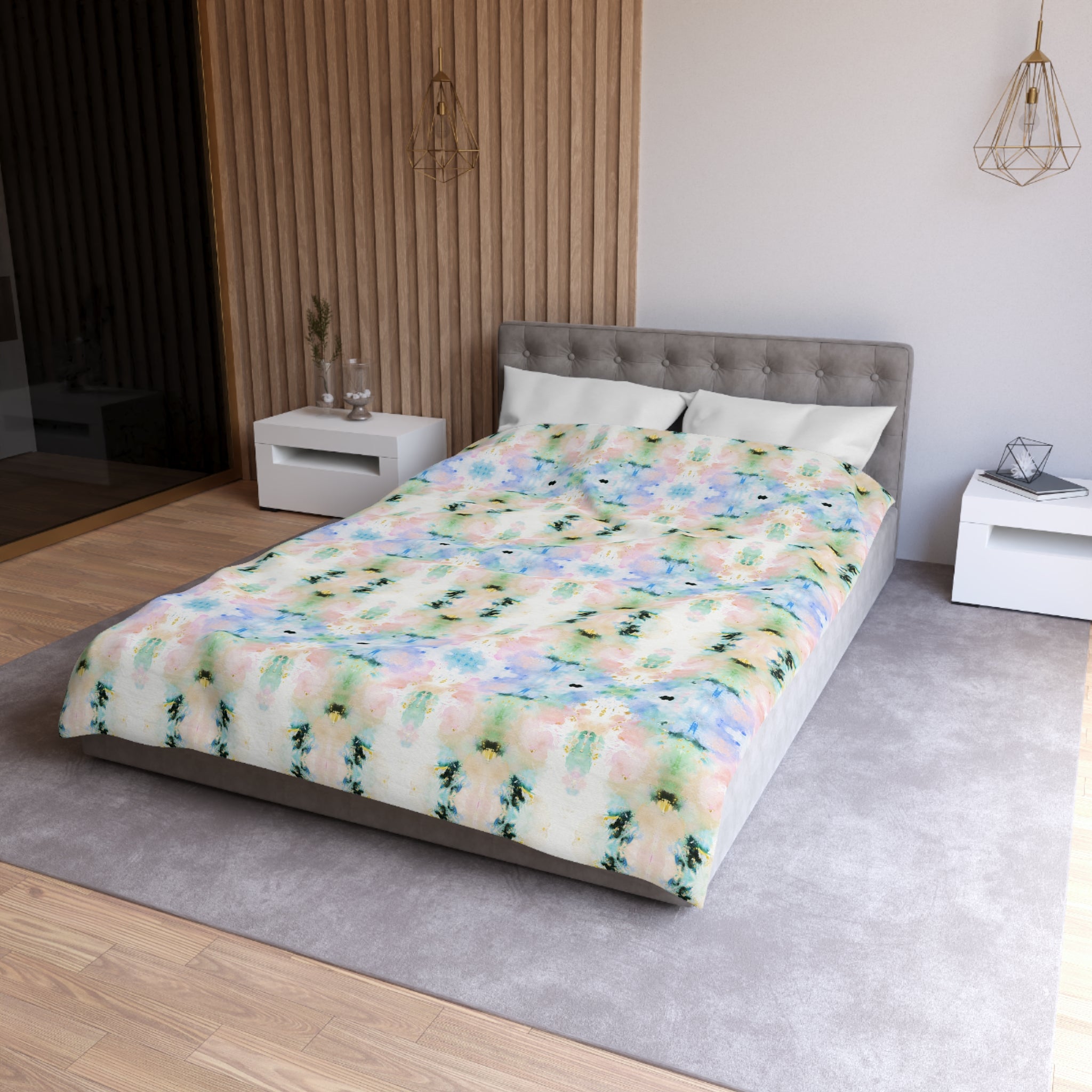 a modern bedroom with a gray tufted headboard, a colorful patterned comforter, and white nightstands.