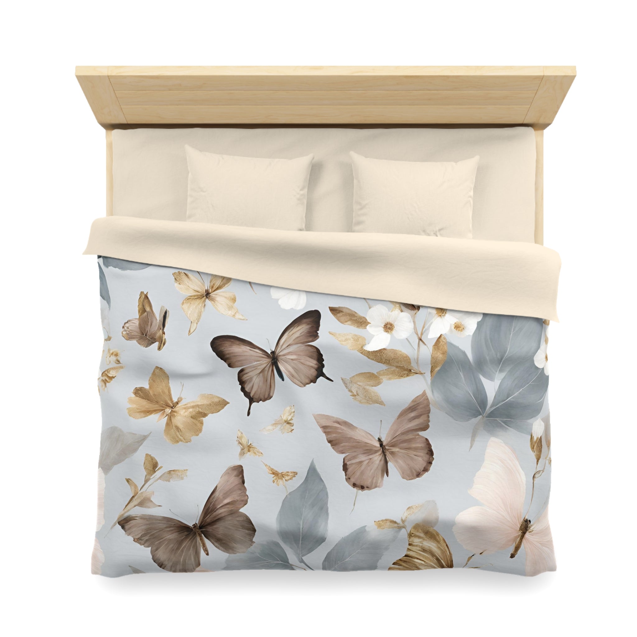 a bed with a light-colored comforter and pillows, featuring a pattern of brown and white butterflies on a light blue background.