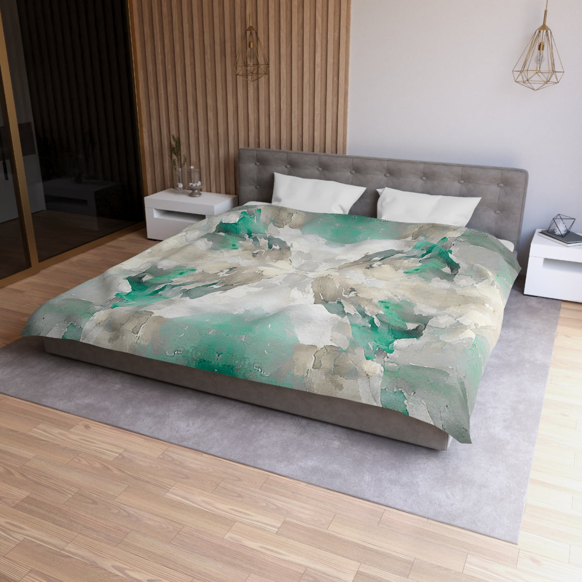 a modern bedroom with a large bed covered in a colorful, abstract-patterned comforter. The bed is positioned against a wall with a wooden panel, and there are two nightstands on either side of the bed. The room has a minimalist and contemporary design, with a gray headboard and a wooden floor.