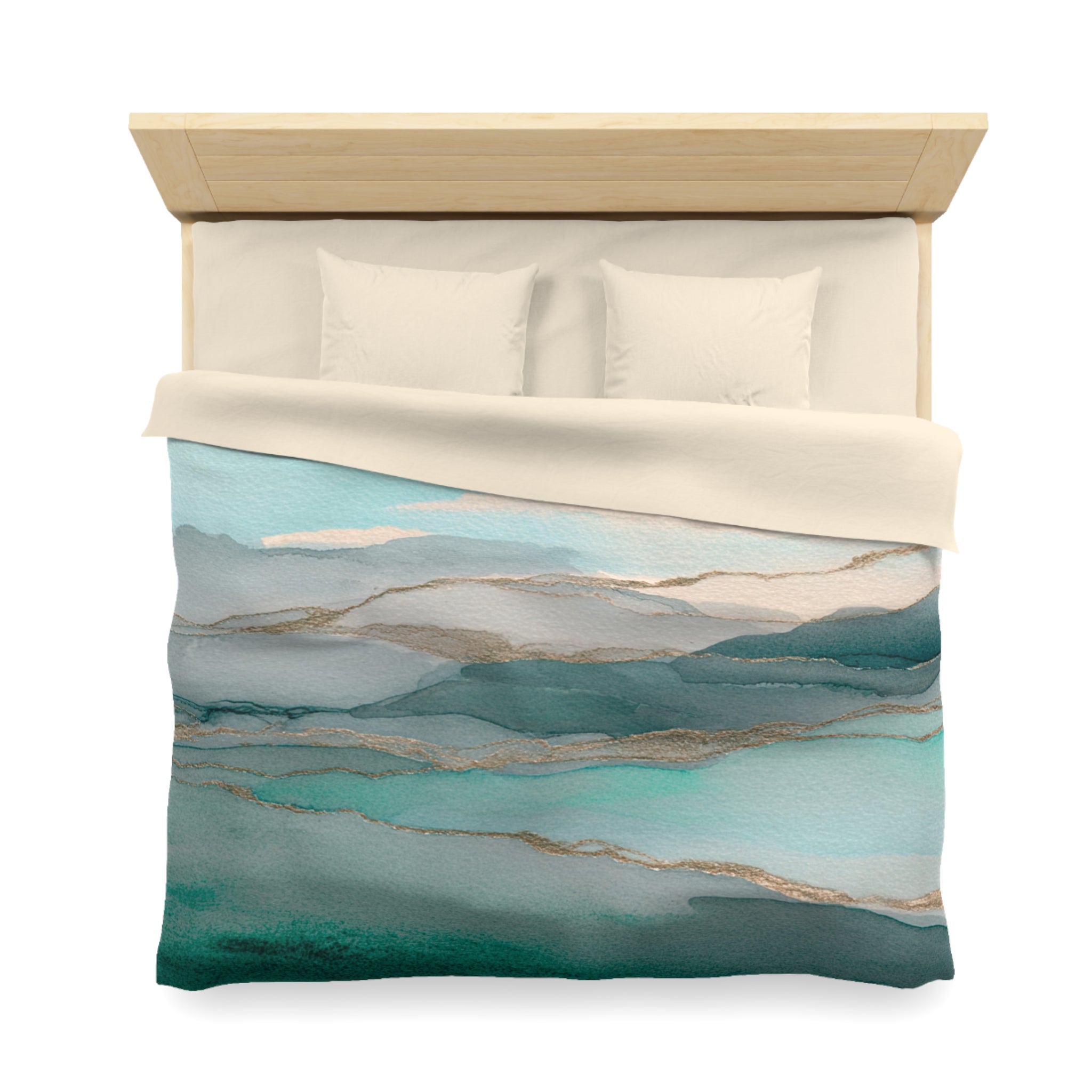 a neatly made bed with a blue and green watercolor-style comforter and pillows.