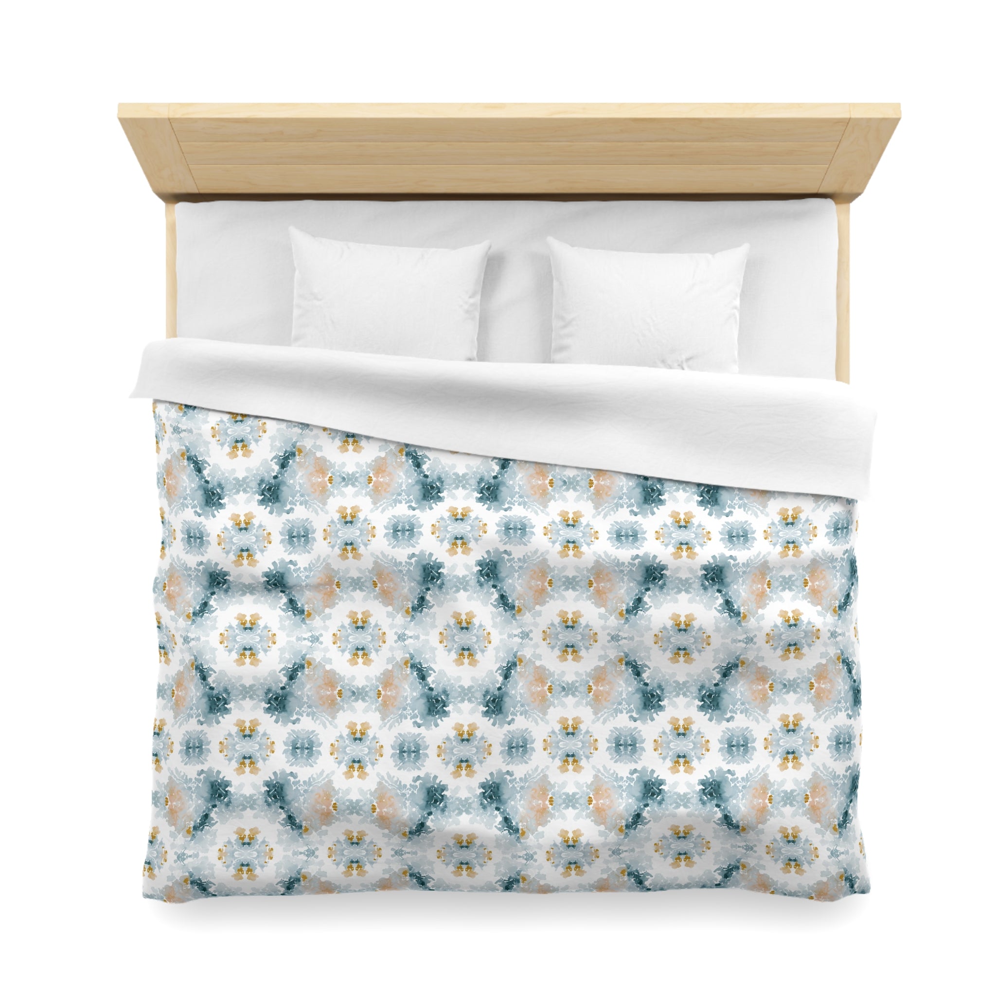 a neatly made bed with a patterned comforter and pillows.