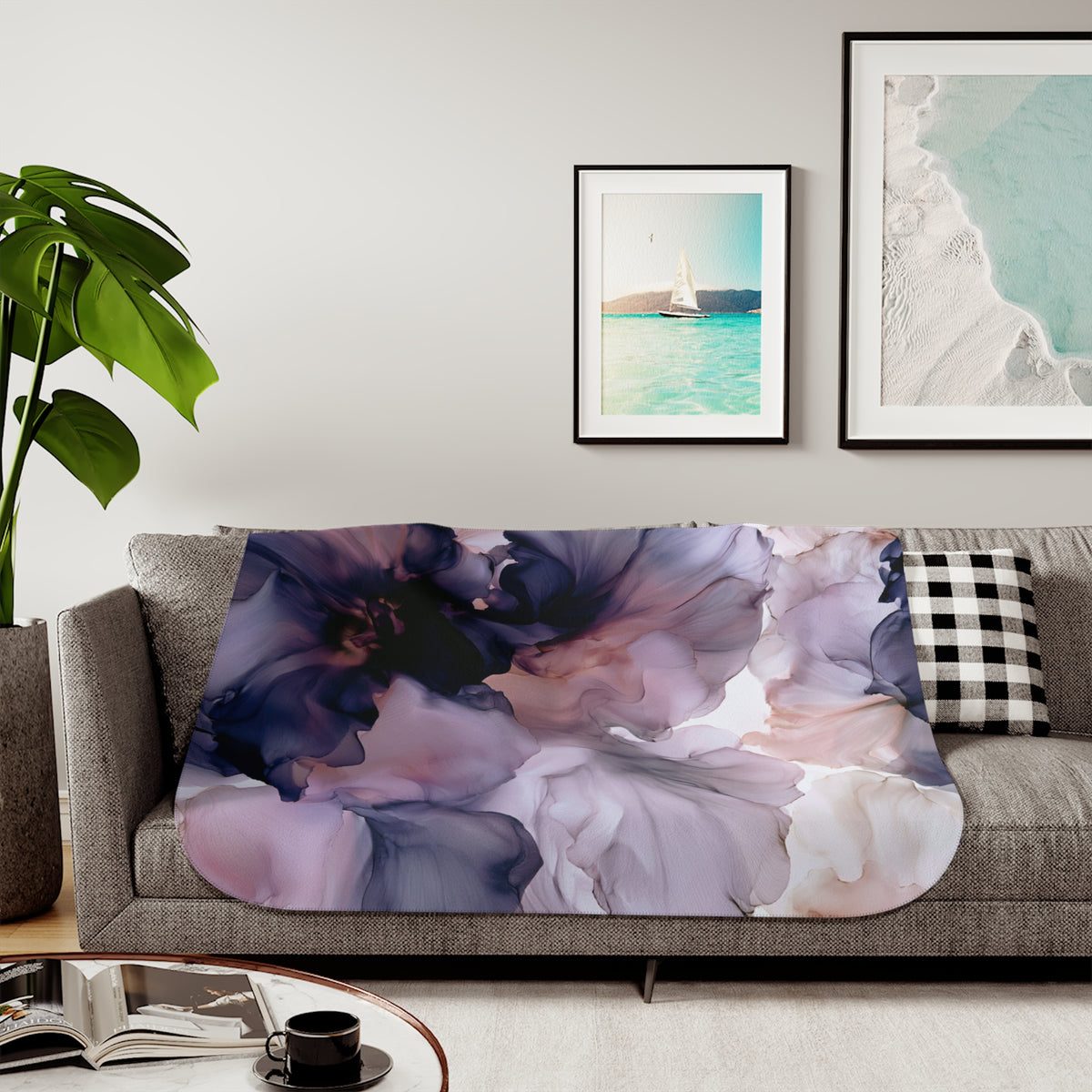 a living room with a couch, coffee table and pictures on the wall