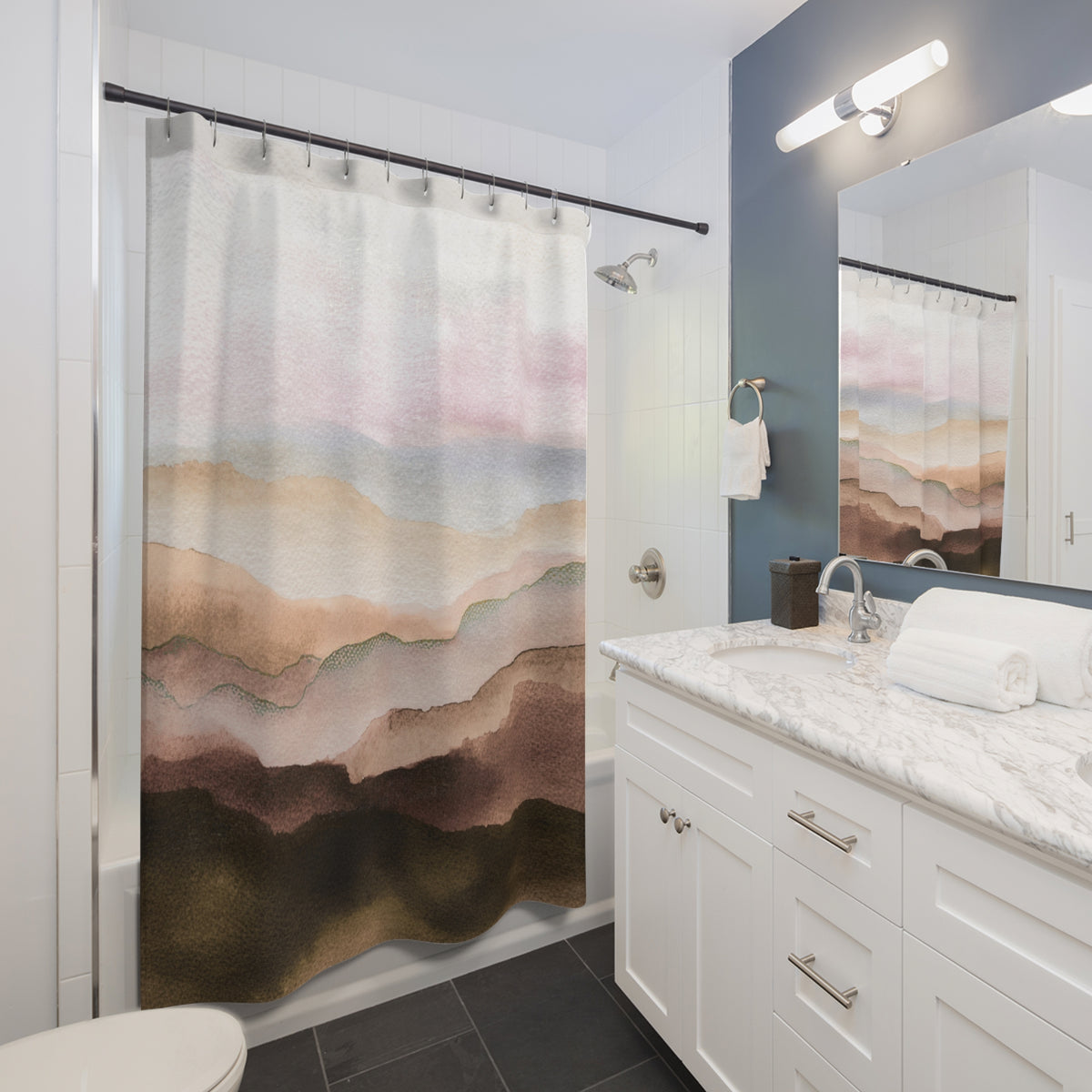 a modern bathroom with a white vanity, a shower curtain featuring a mountain landscape, and a mirror above the vanity.