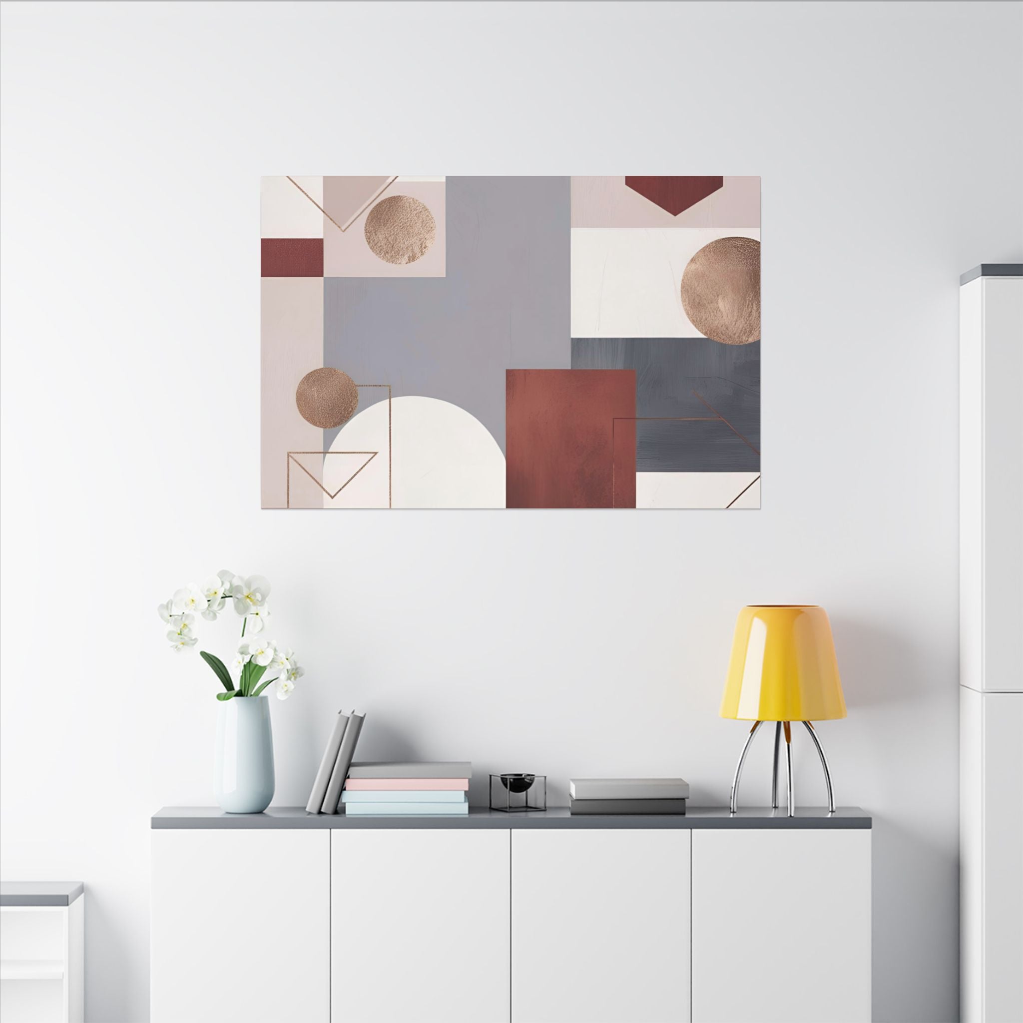 a minimalist living space with a white wall, a white cabinet, a yellow lamp, a vase with white flowers, and a painting of abstract geometric shapes.