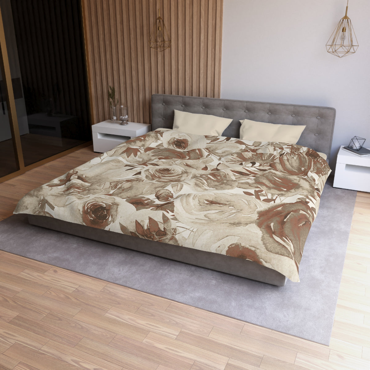 a modern bedroom with a large bed, a gray headboard, and a floral print bedspread. The room has a wooden floor and white walls, creating a warm and inviting atmosphere.