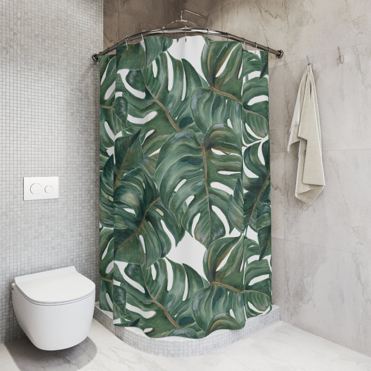 a bathroom with a shower curtain adorned with a tropical leaf pattern. The shower curtain is hanging from a rod, and there is a towel hanging on the wall next to it. The bathroom has a white toilet and a tiled wall, creating a clean and modern aesthetic.