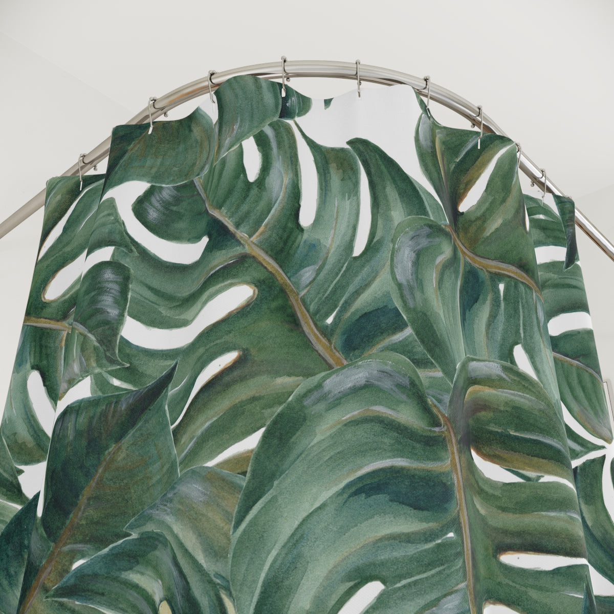a large, vibrant green leaf pattern with a curved metal rod above it.