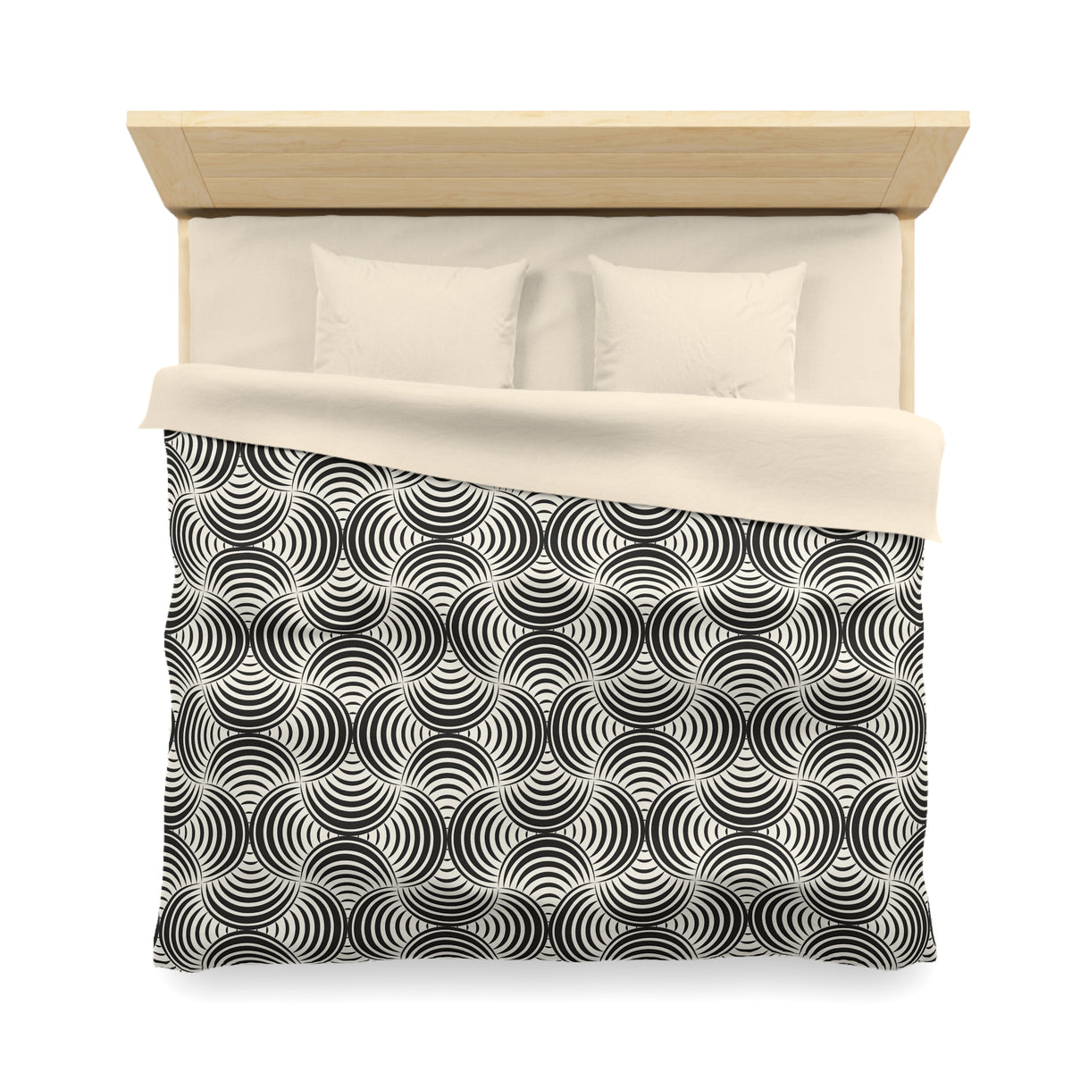 a neatly made bed with a black and white patterned comforter and pillows.