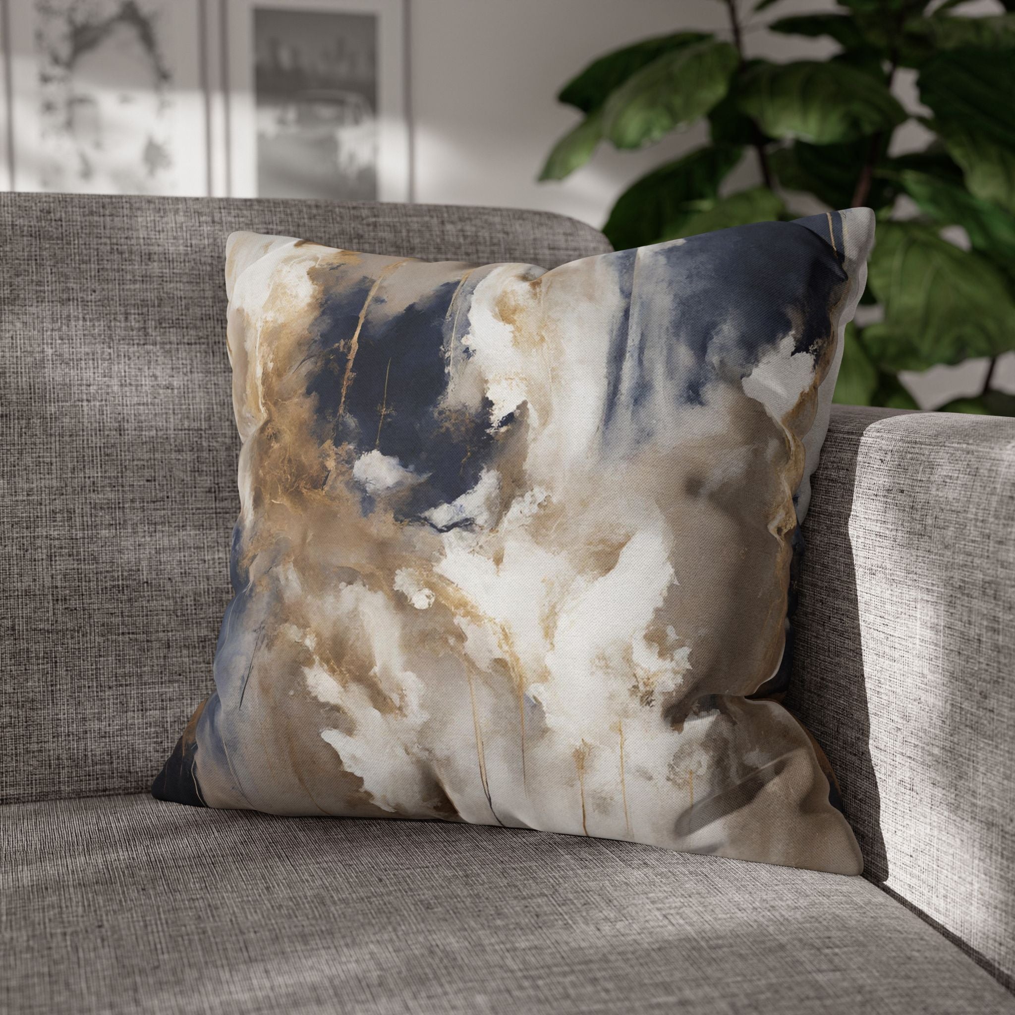 a gray sofa with a decorative throw pillow featuring an abstract design in shades of blue, white, and brown.