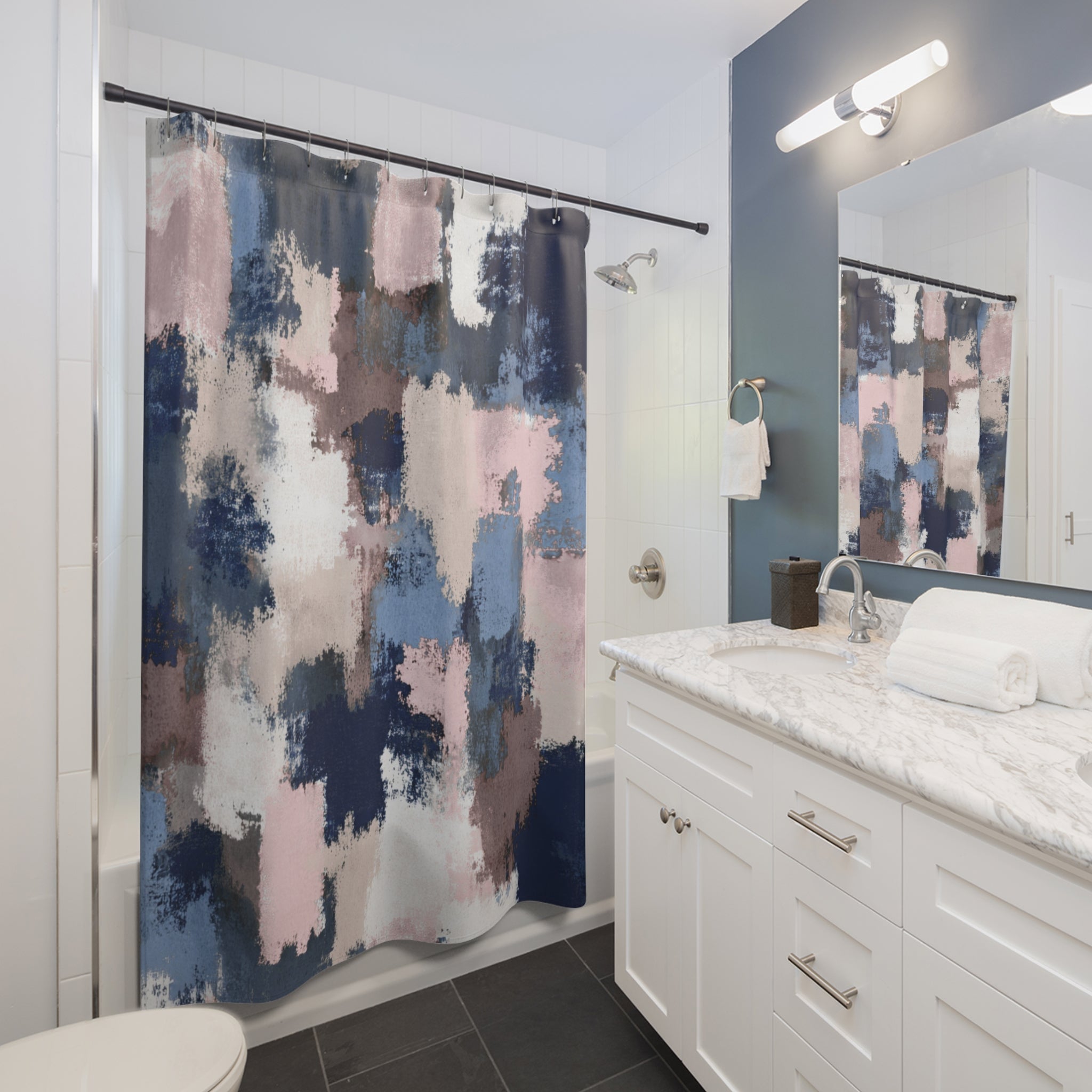 a modern bathroom with a white vanity, a shower curtain with a colorful abstract pattern, and a mirror above the vanity.