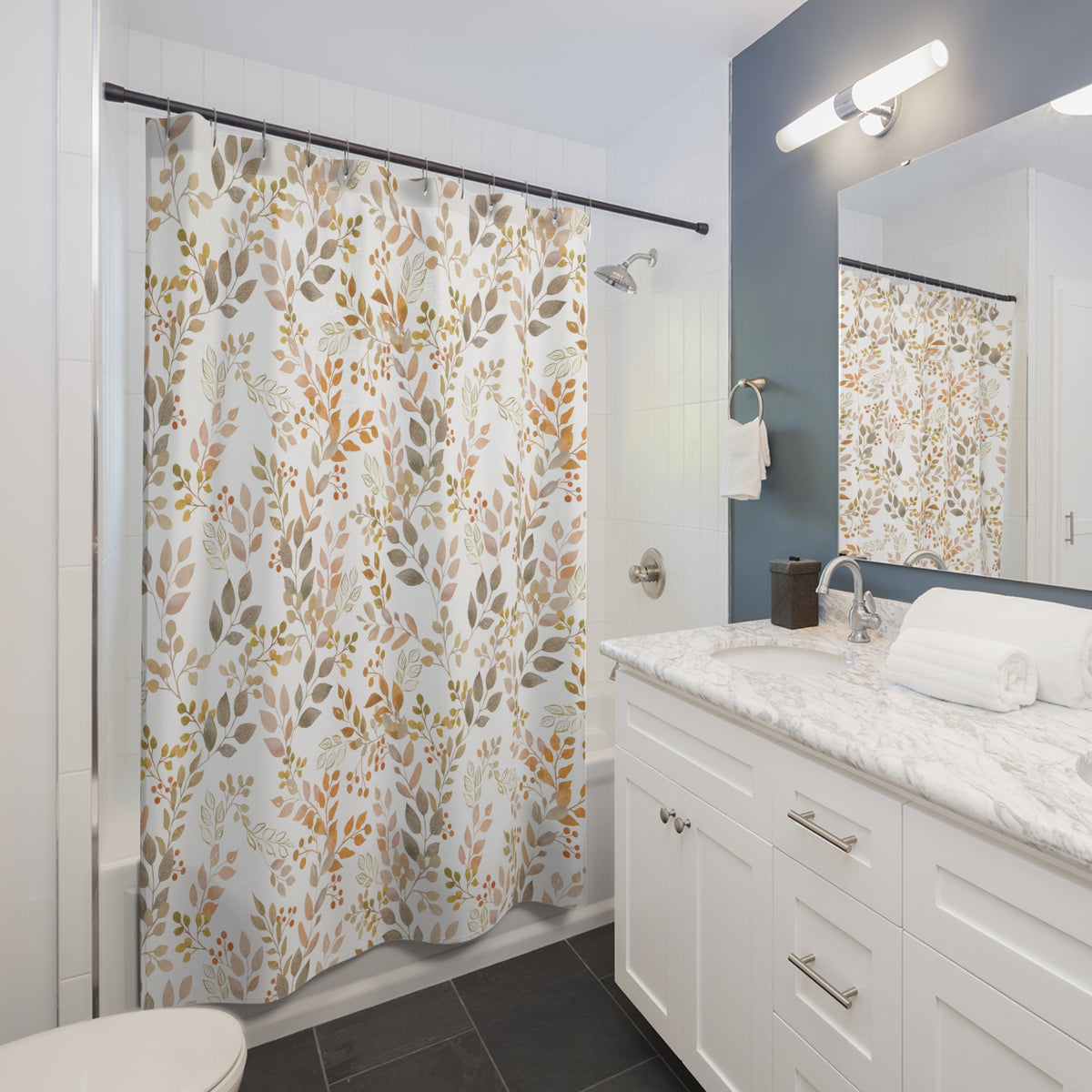 a modern bathroom with a white vanity, a shower curtain with a leafy pattern, and a mirror above the sink.
