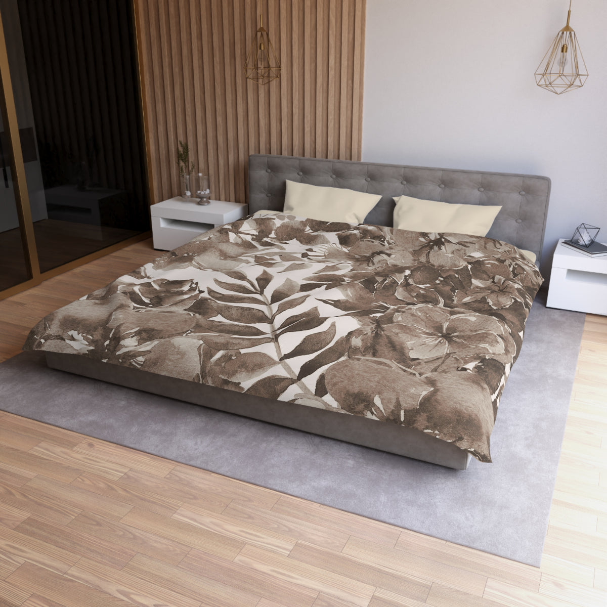 a modern bedroom with a large bed, a gray headboard, and a wooden wall. The bed is covered in a brown and white floral comforter, and there are two pillows on the bed. The room has a wooden floor and a gray area rug. There are also two nightstands on either side of the bed, and a pendant light hanging above the bed.