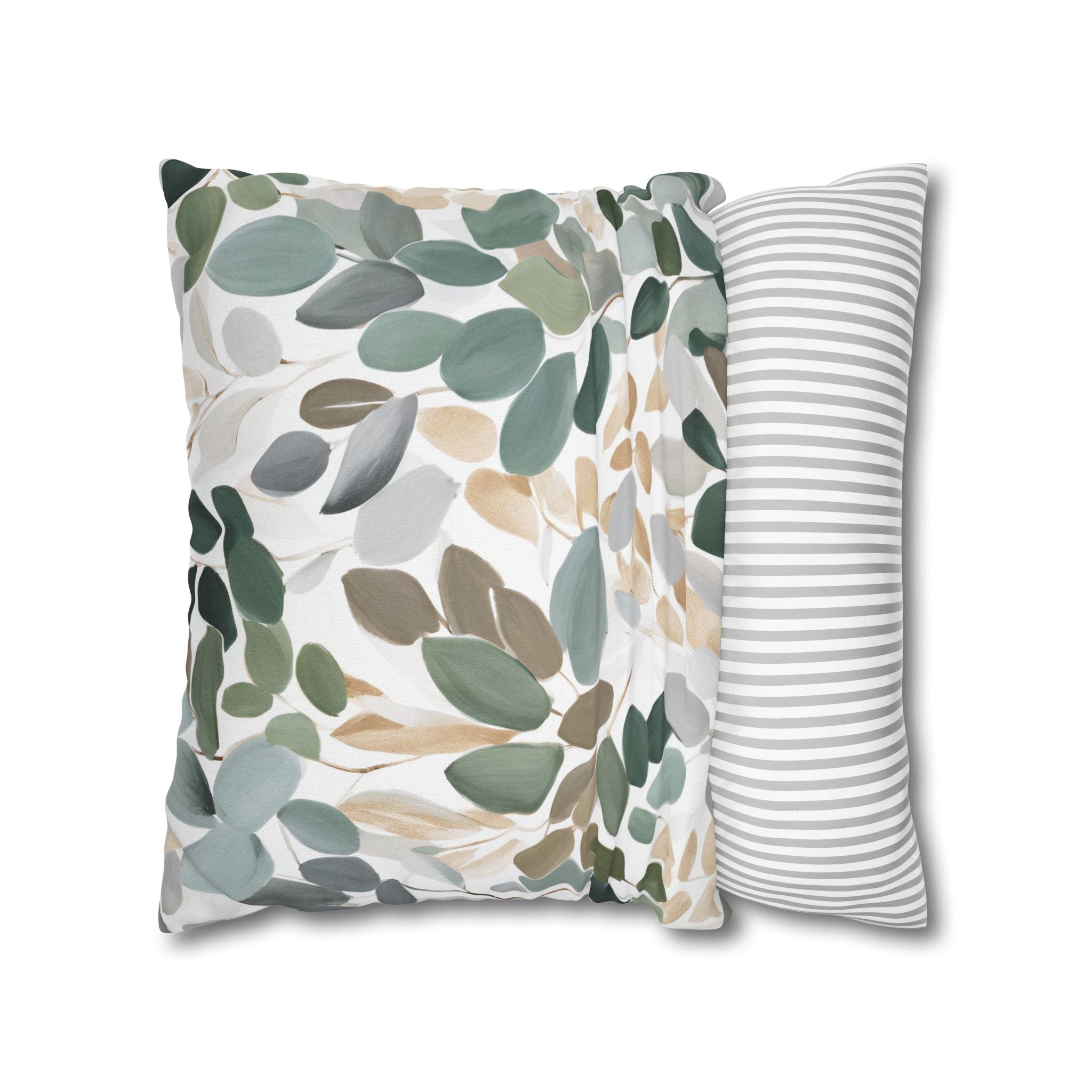 a decorative pillow with a leafy pattern in shades of green and brown.