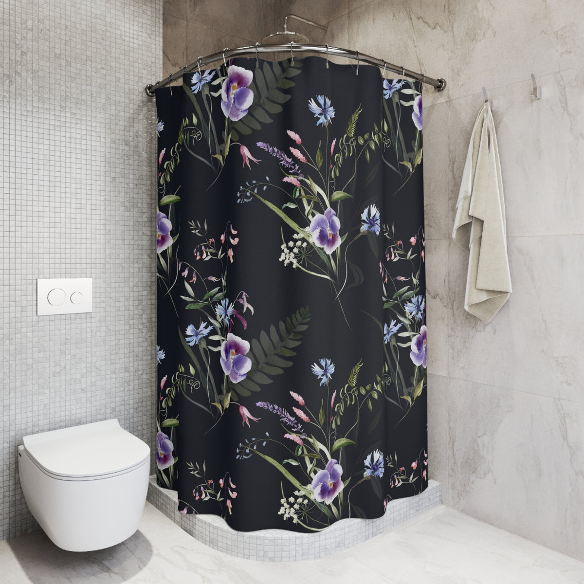 a bathroom with a shower curtain adorned with a floral pattern in shades of purple and blue. The shower curtain is hanging from a rod next to a white towel. The bathroom has a white toilet and a tiled wall, creating a clean and modern aesthetic.