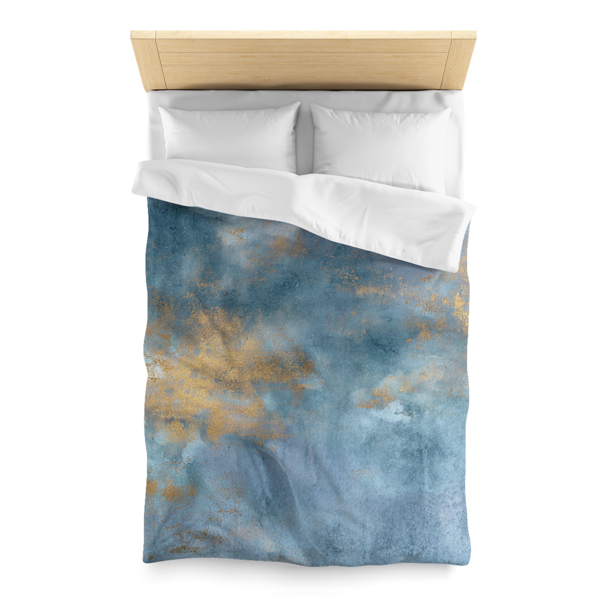 a bed with a blue and gold patterned comforter and pillows.