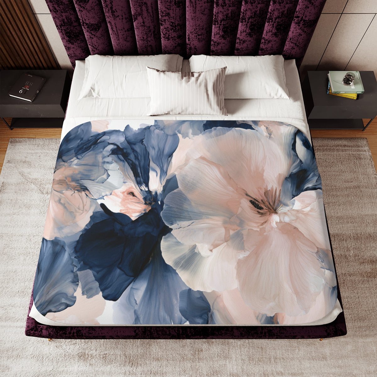 a bed with a floral comforter and pillows