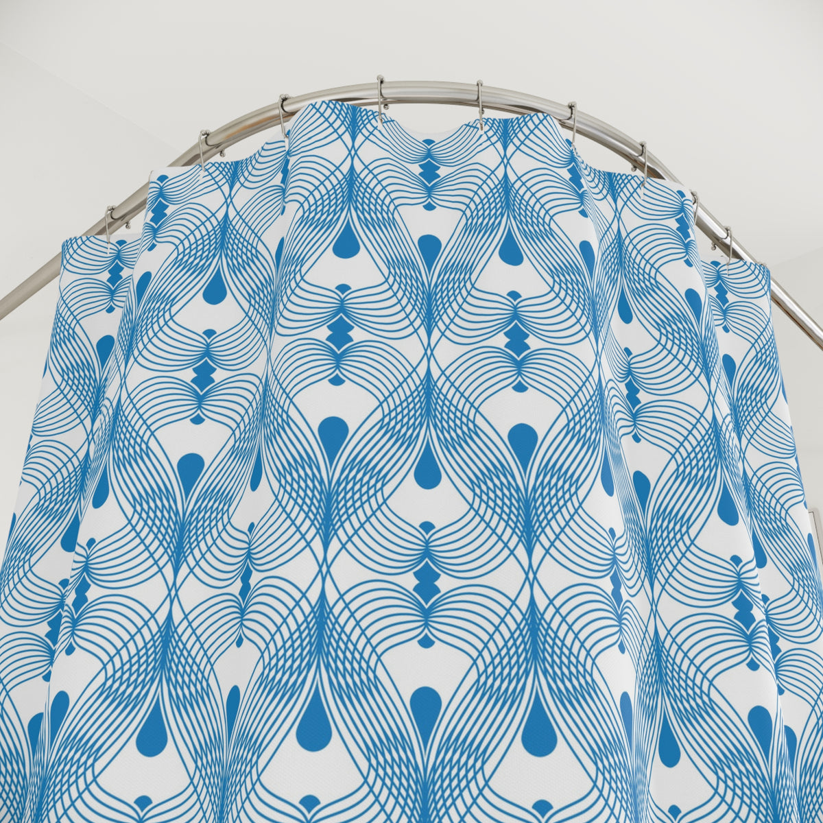 a blue and white patterned shower curtain with a repeating geometric design.